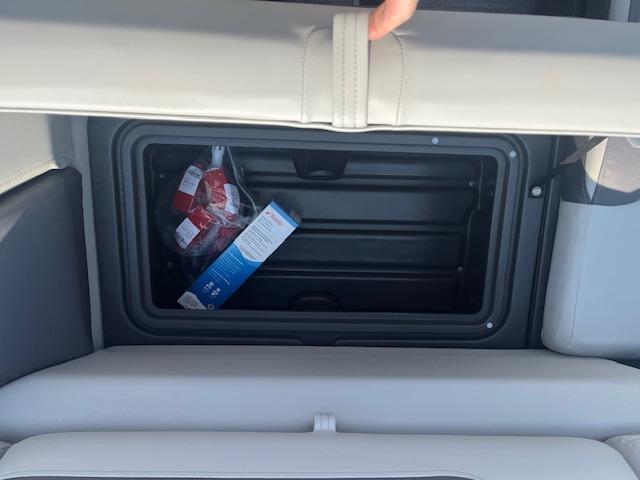 Storage compartment in 2026 Sun Tracker Fishin' Barge 20 DLX with snacks inside.