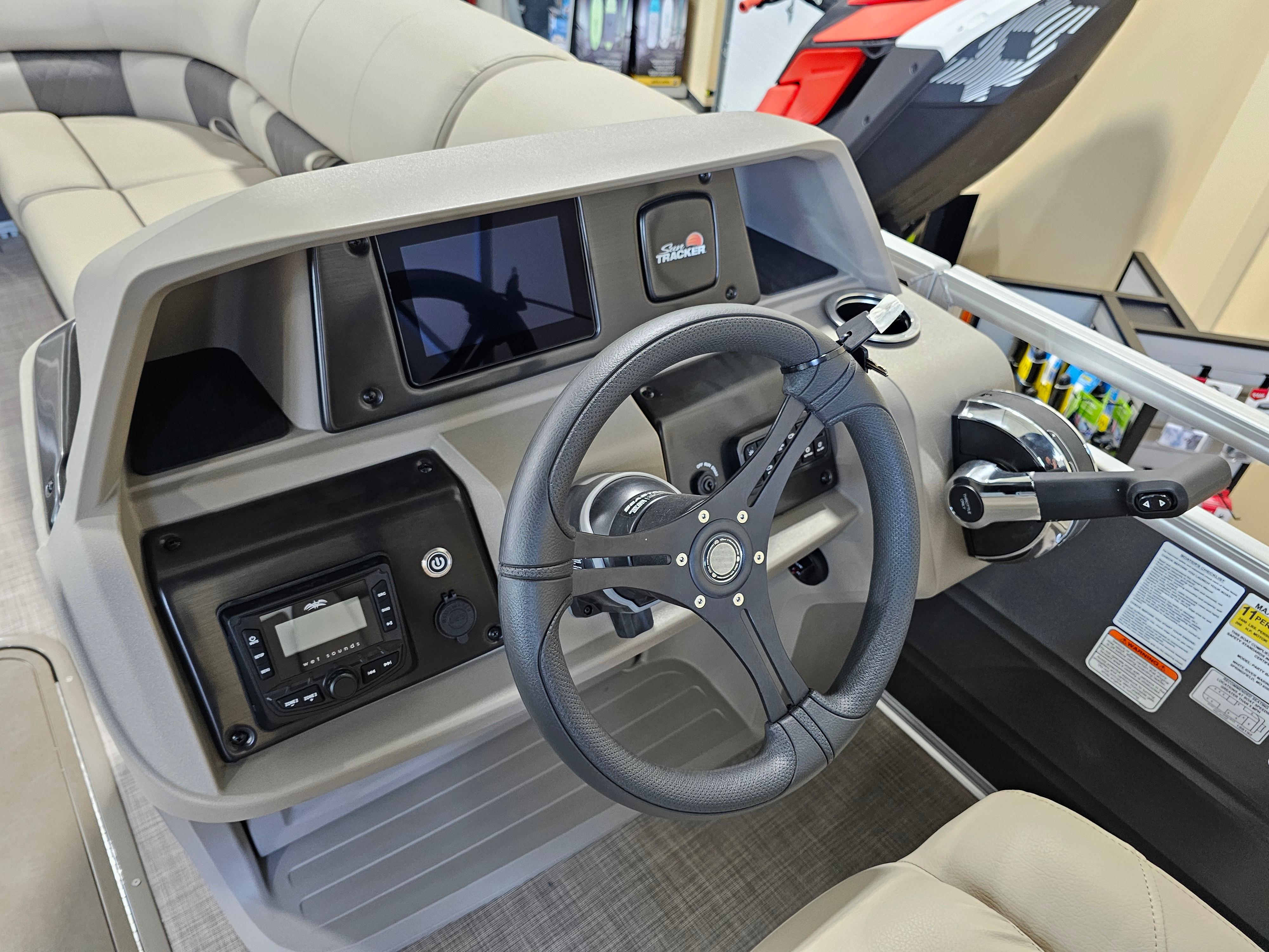 2024 Sun Tracker Party Barge 22 RF XP3 dashboard with steering wheel and controls.