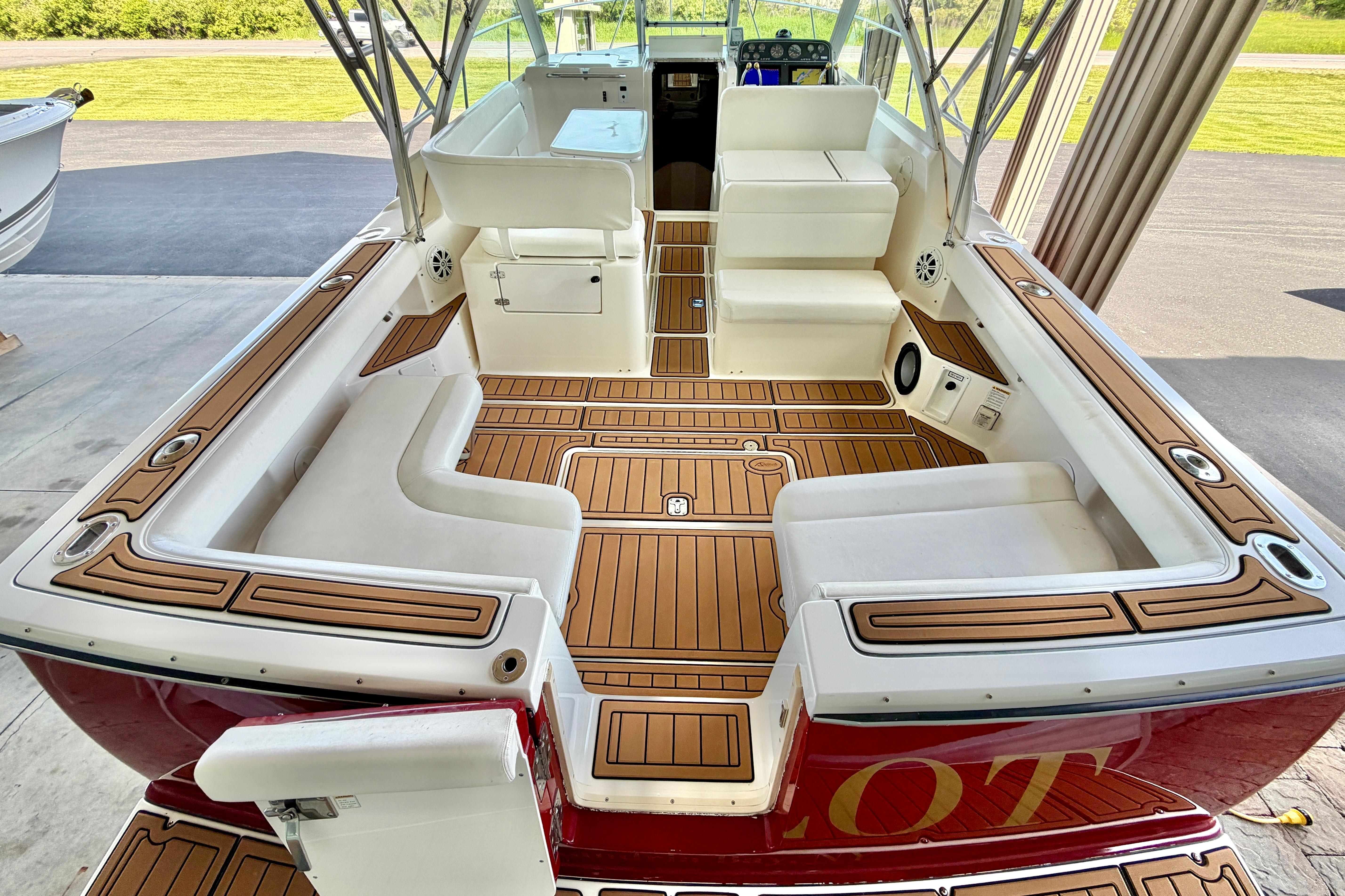 1999 Tiara Yachts 2900 Coronet interior with teak flooring and white seating.