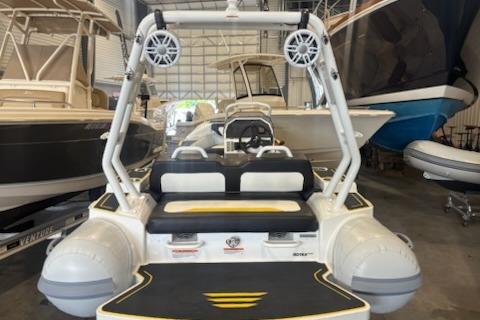 2026 Highfield Velox 420 boat in a showroom, featuring modern design and seating.