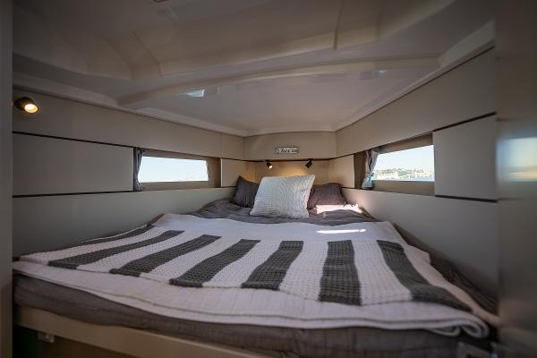 Interior of Beneteau Oceanis 38.1 yacht, cozy sleeping cabin.