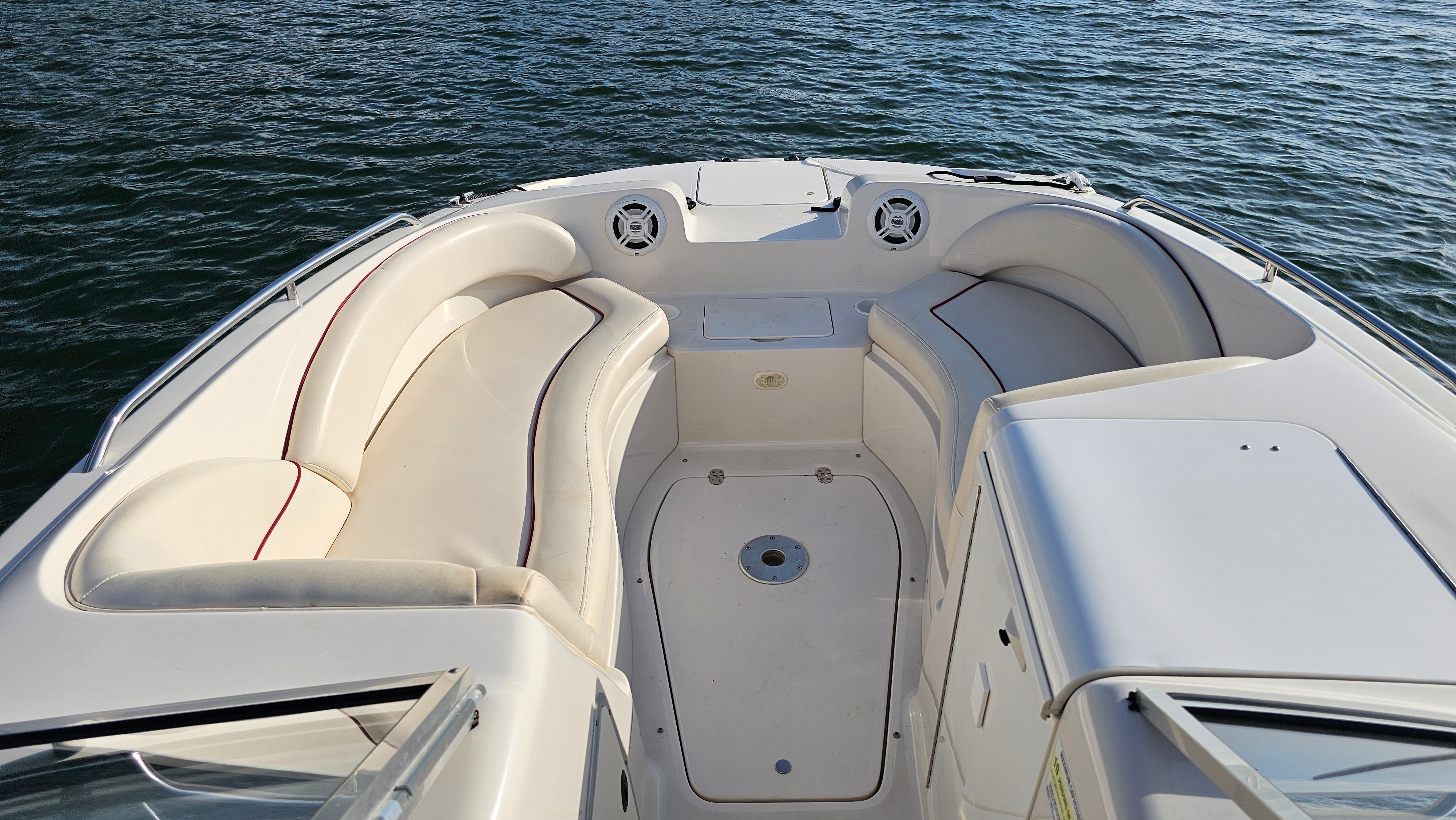 The image shows the bow seating area of a 2002 Monterey 220 Explorer Sport boat on the water.