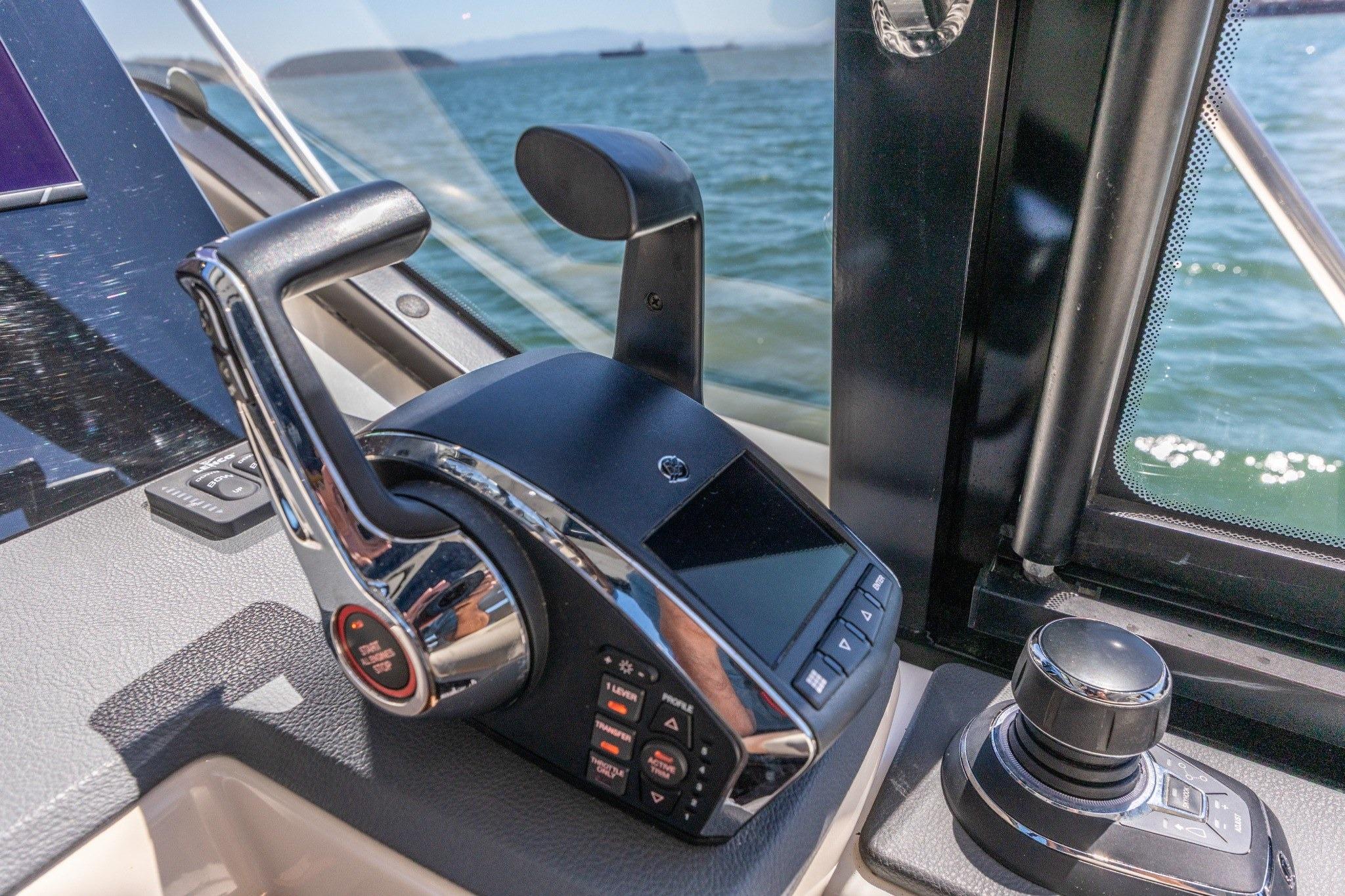Control panel of 2023 Boston Whaler 405 Conquest boat with throttle and joystick.