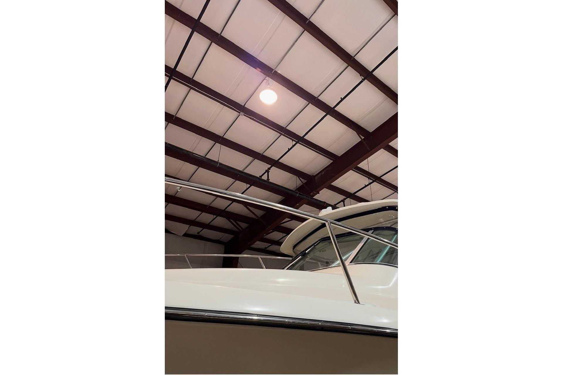 2000 Pursuit 3070 Offshore Center Console boat in indoor storage facility.