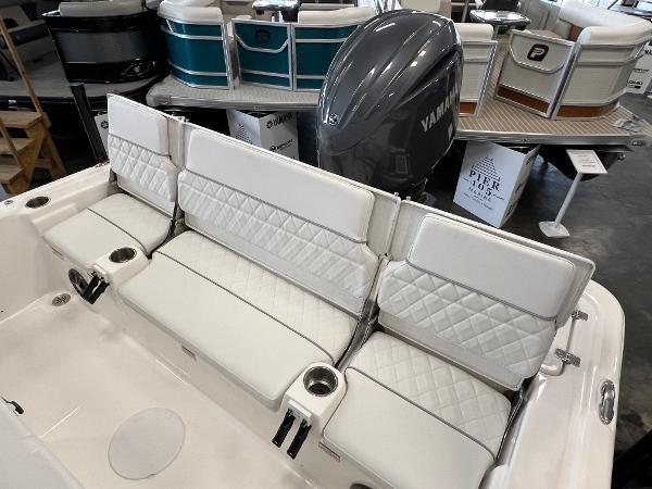 2024 Sea Fox 231 Bay boat with white cushioned seating and Yamaha outboard motor.