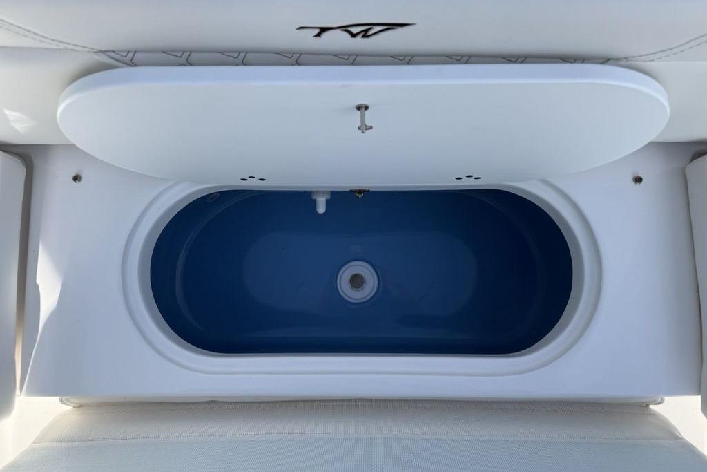 2026 Tidewater 232 LXF boat livewell with open lid, showcasing interior design.