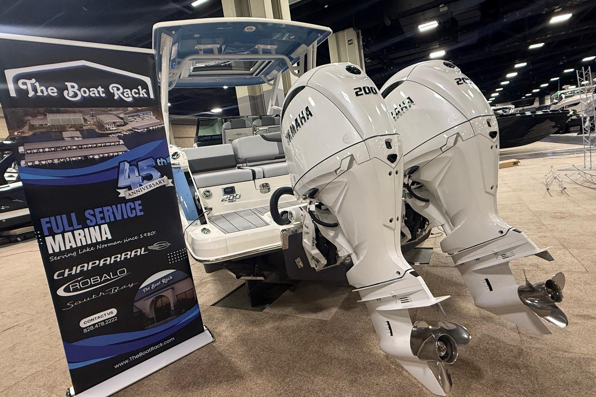 2026 Chaparral 280 OSX boat with Yamaha engines at The Boat Rack marina display.