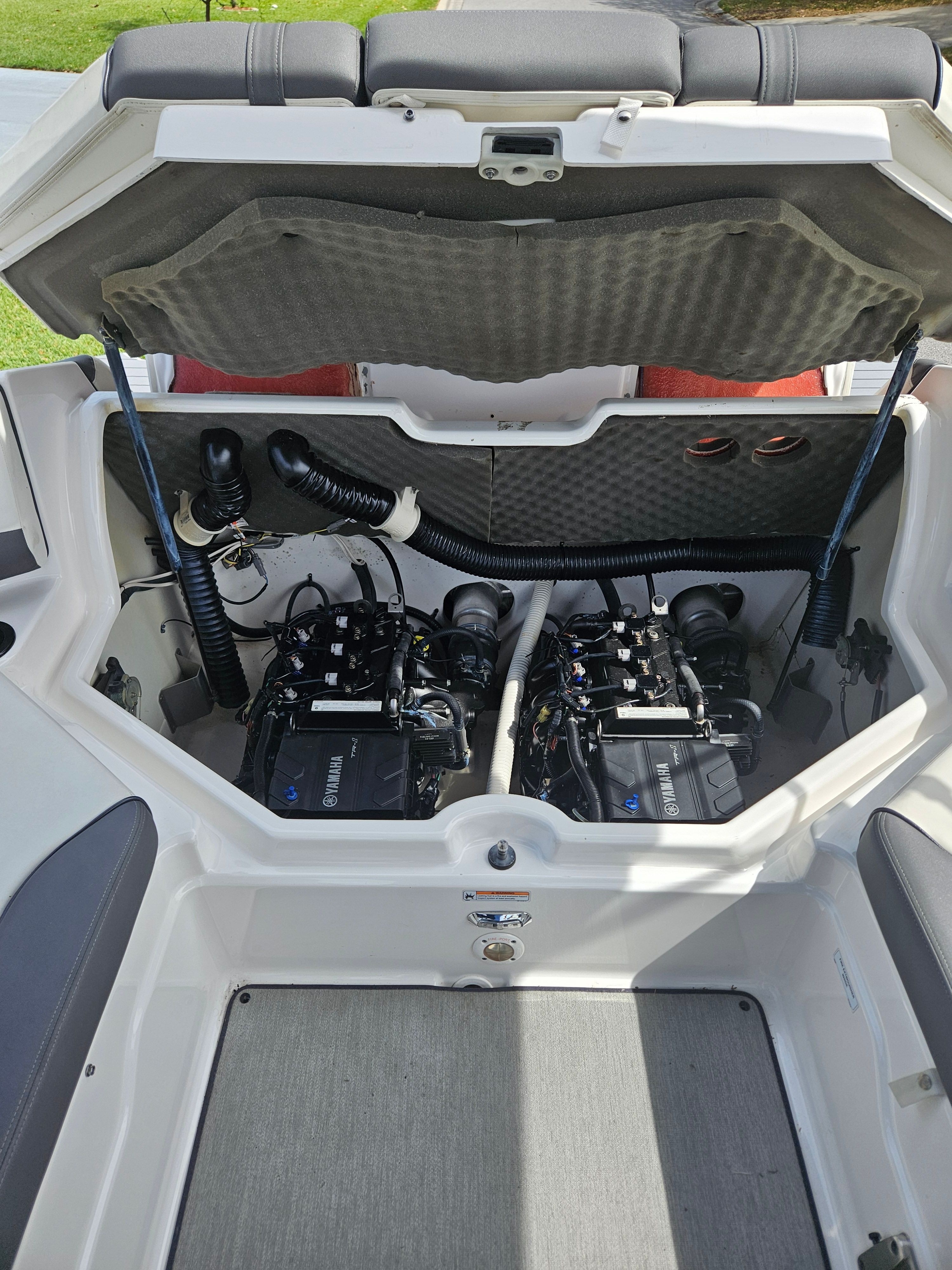 Engine compartment of a 2022 Yamaha SX210 boat with dual engines.