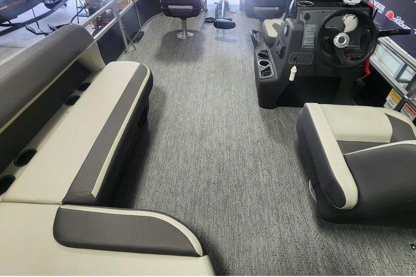 2026 Sun Tracker Bass Buggy 16 DLX interior with gray carpet and cushioned seating.