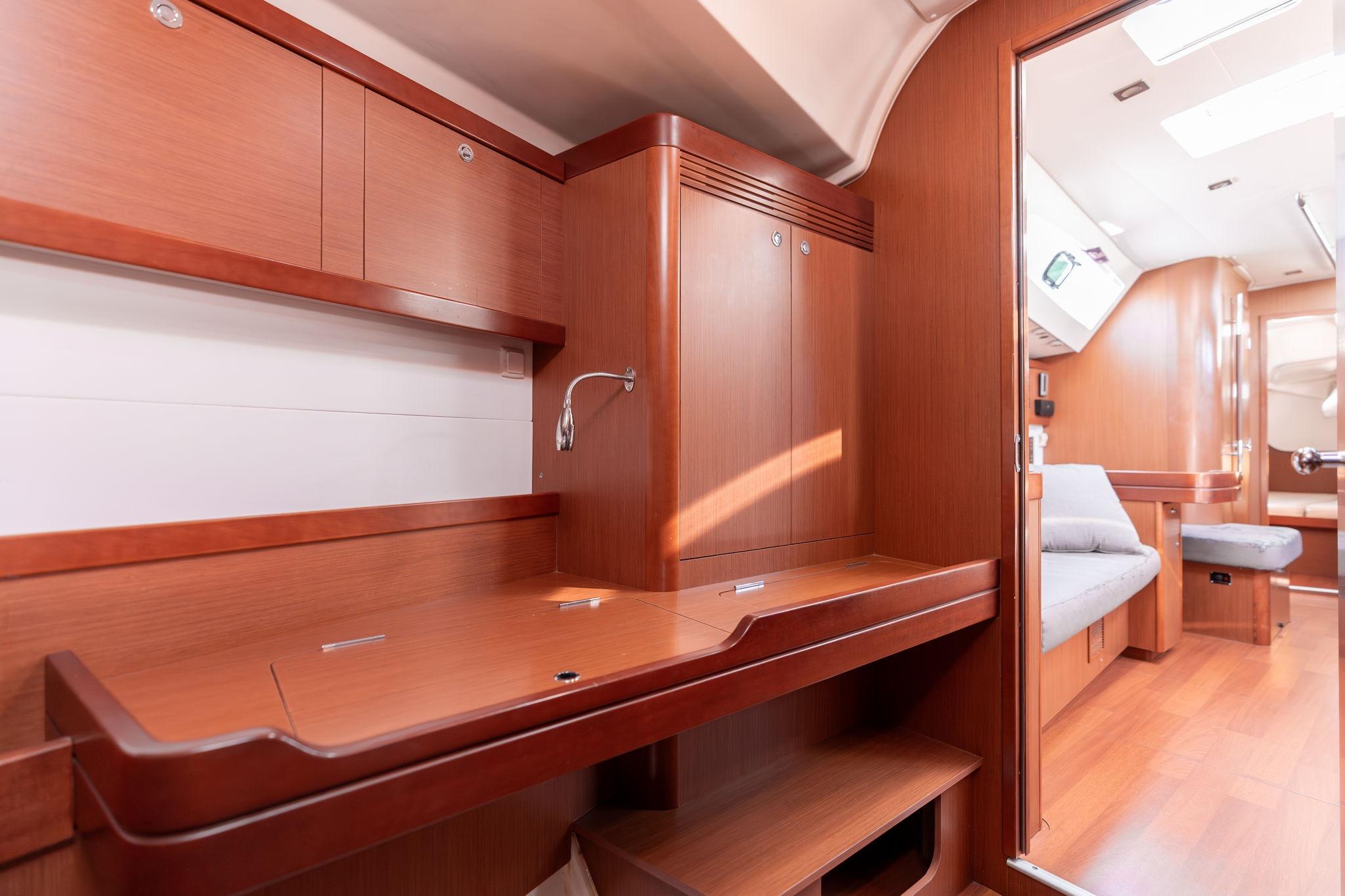 2013 Beneteau Oceanis 50 interior with wooden cabinetry and seating area.