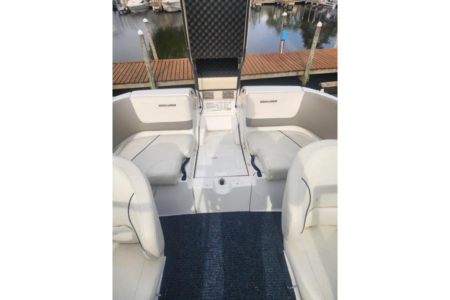2012 Sea-Doo Sport Boats 180 Challenger interior with seating and storage, dockside view.