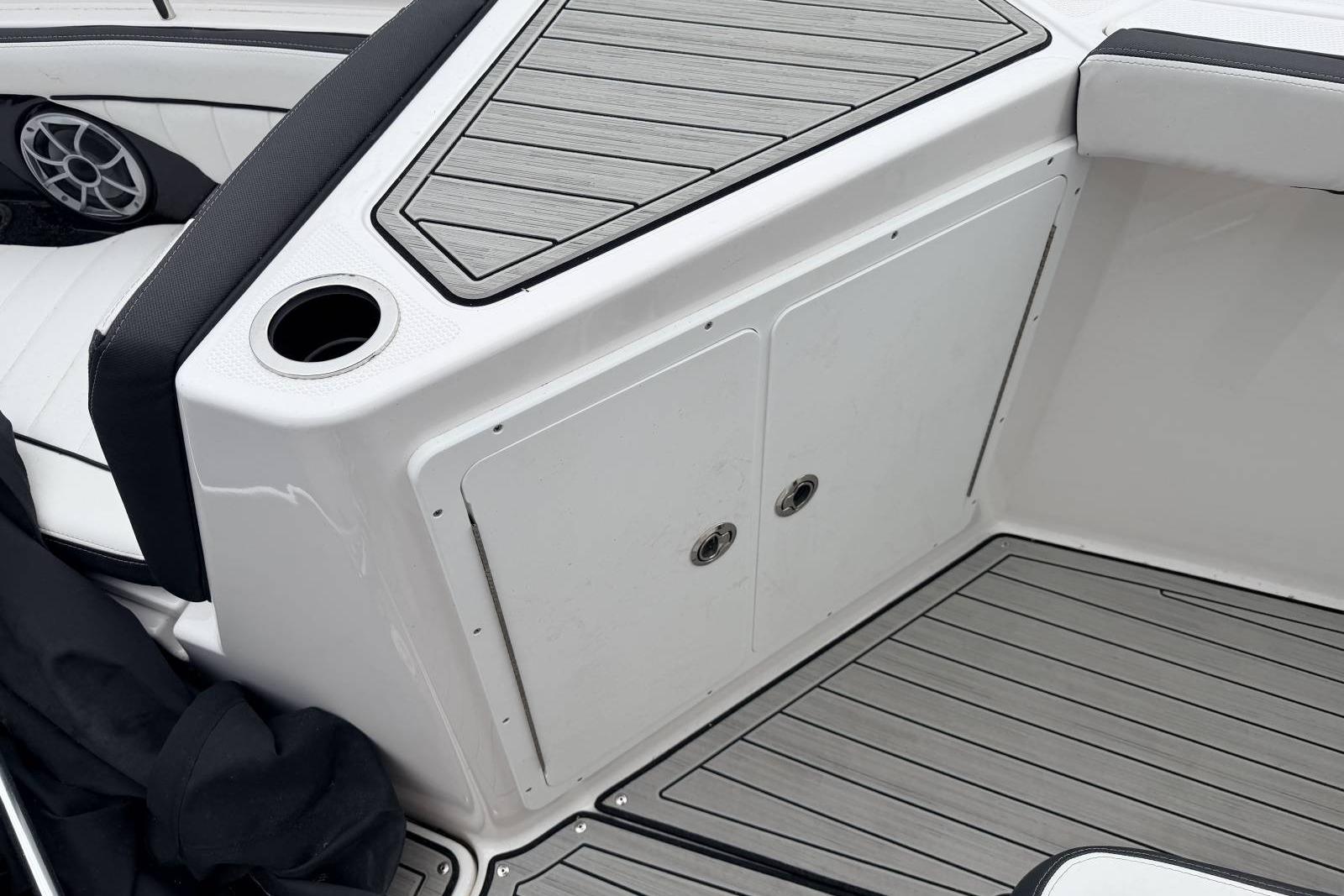 2023 Yamaha Boats 255 FSH Sport E interior with sleek seating and storage compartments.