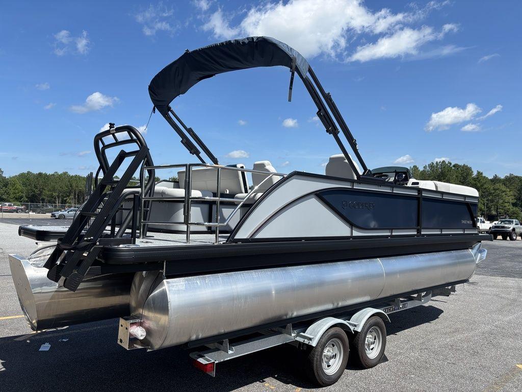 2026 Godfrey SWEETWATER 2286 SFL pontoon boat on trailer under blue sky.