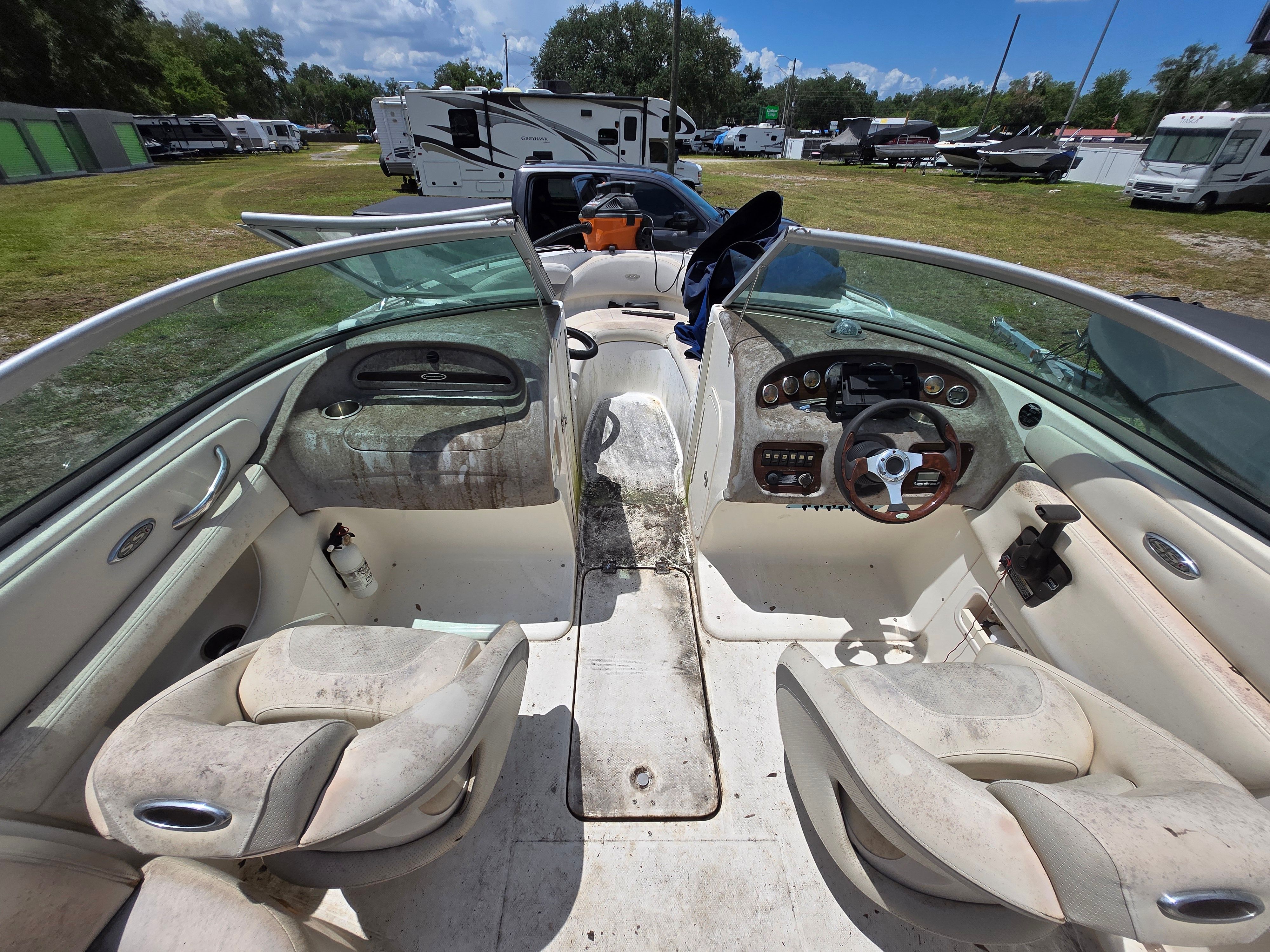 The image shows the cockpit of a 2006 Chaparral 220 SSi with two seats and a helm.