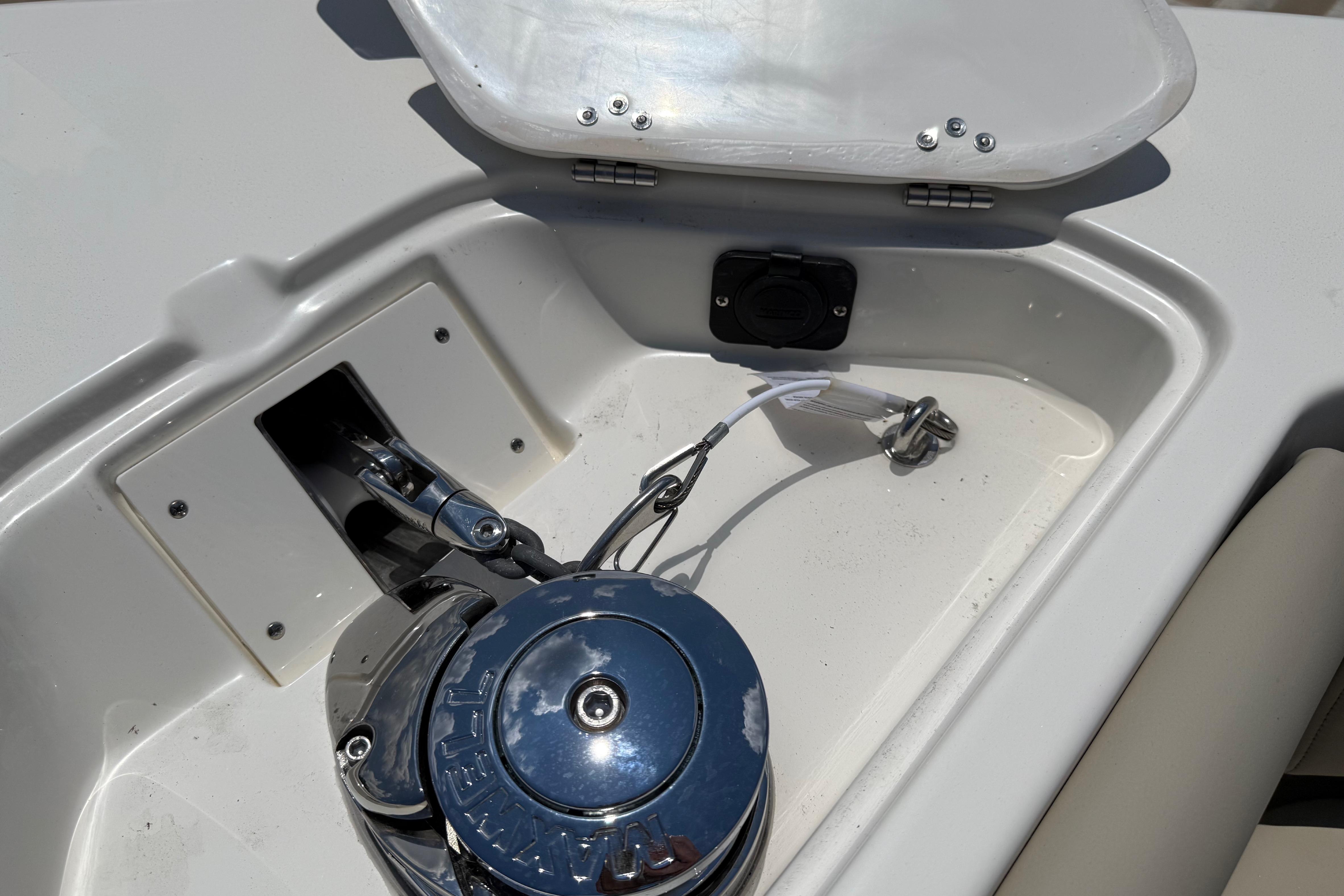 Anchor compartment of 2027 Key West 249 FS boat with winch and open hatch.
