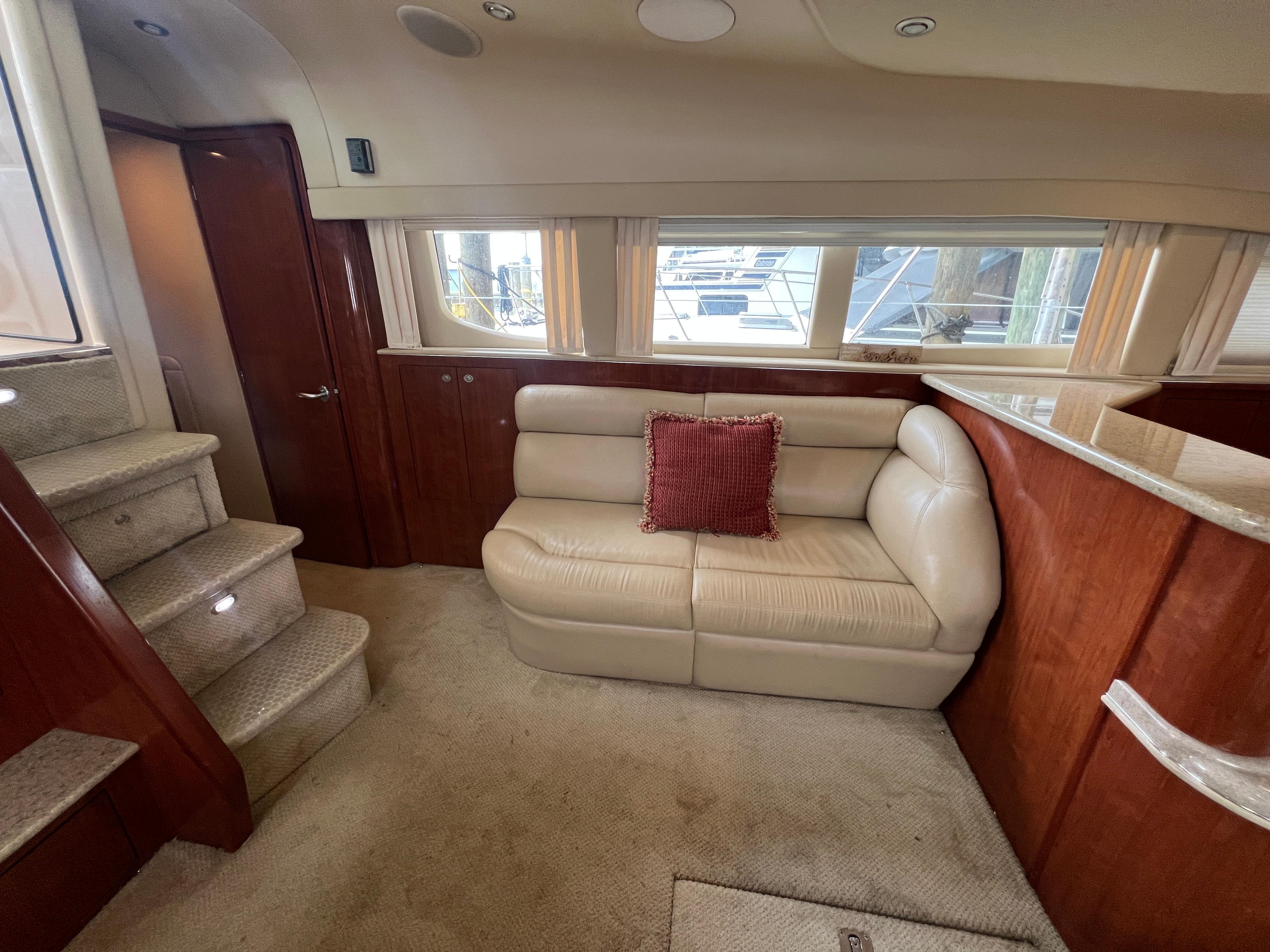 Luxurious interior of 2004 Sea Ray 480 Motor Yacht with plush seating and elegant wood finishes.