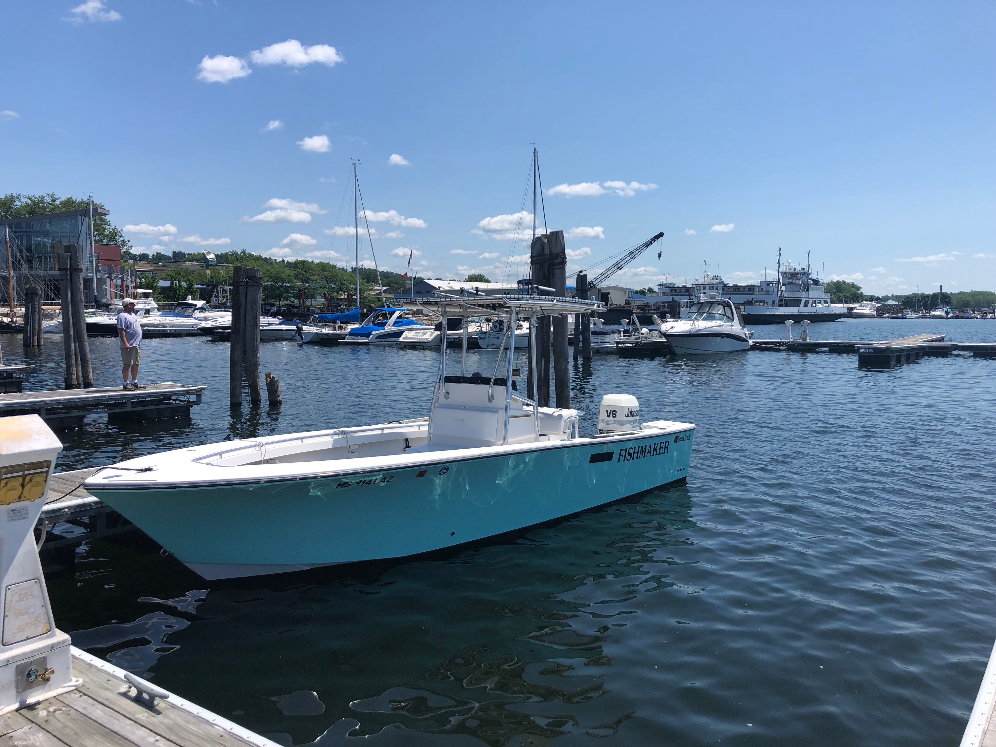 2001 SeaCraft boat SXCRB730H001 docked in sunny harbor.