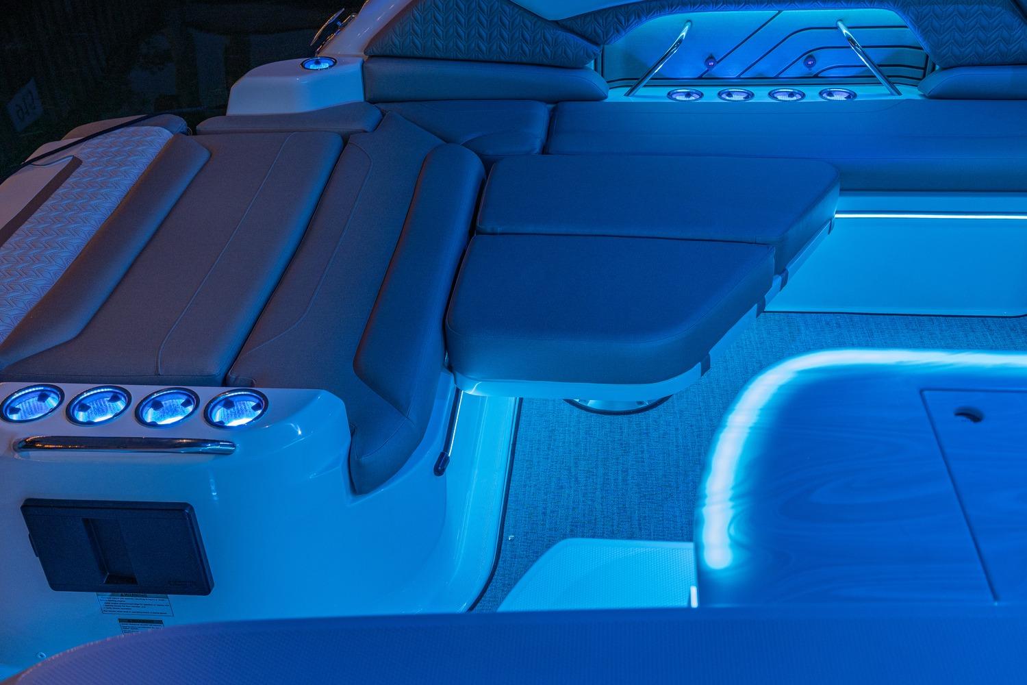 Luxurious interior of 2026 Hurricane SunDeck 3200 OB with ambient blue lighting.