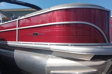 2026 Sun Tracker Party Barge 22 XP3 pontoon boat with red exterior and sleek design.