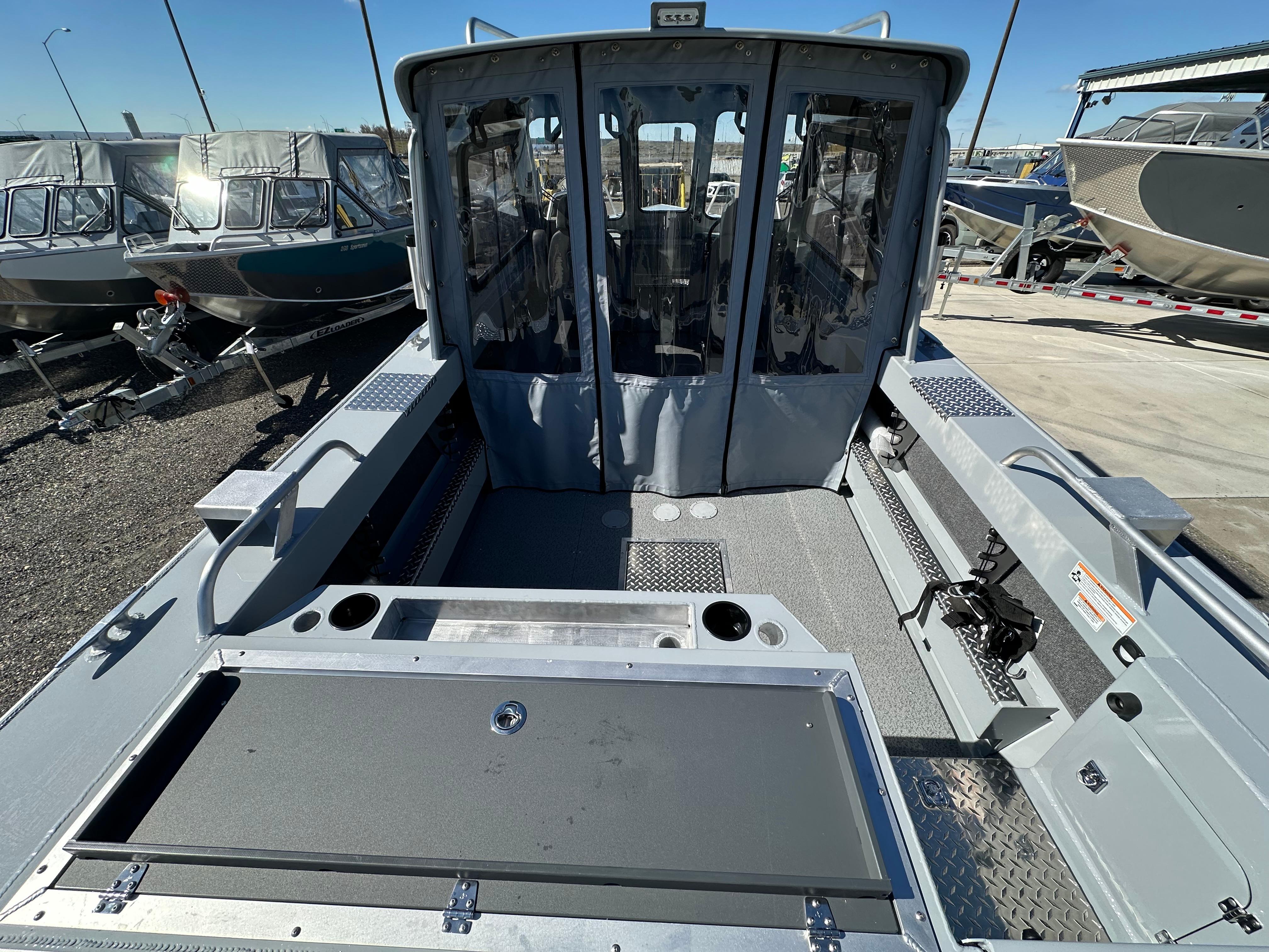 2024 Hewescraft 190 Searunner HT FC boat interior, docked with other boats.