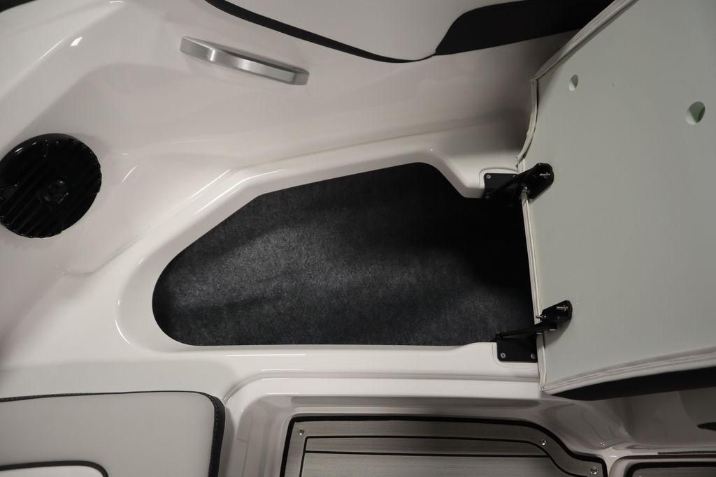 Open storage compartment in 2026 Yamaha Boats 195S, showcasing interior space and design.