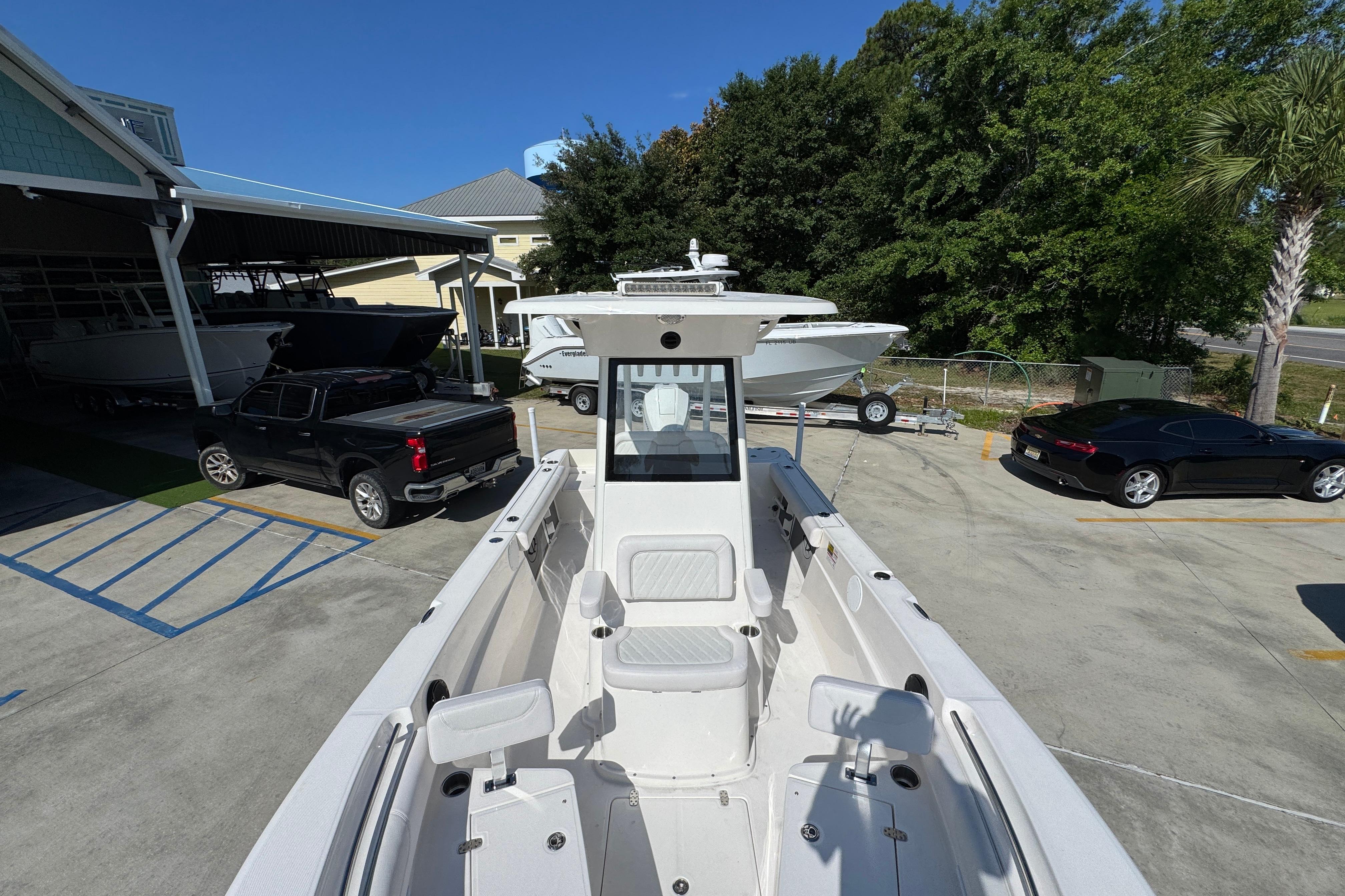 2027 Sea Born LX22 Center Console boat in a parking lot with cars and trees.