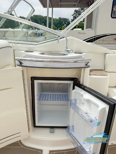 2008 Sea Ray 270 SLX boat with open mini fridge and sink on deck.