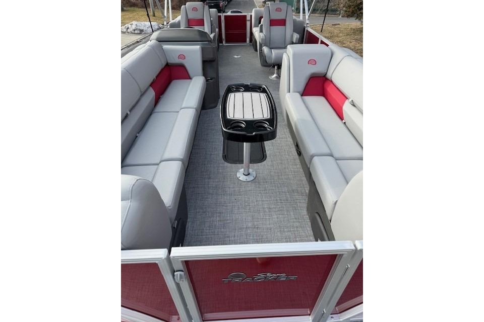 2026 Sun Tracker Party Barge 24 XP3 interior with gray and red seating, central table.
