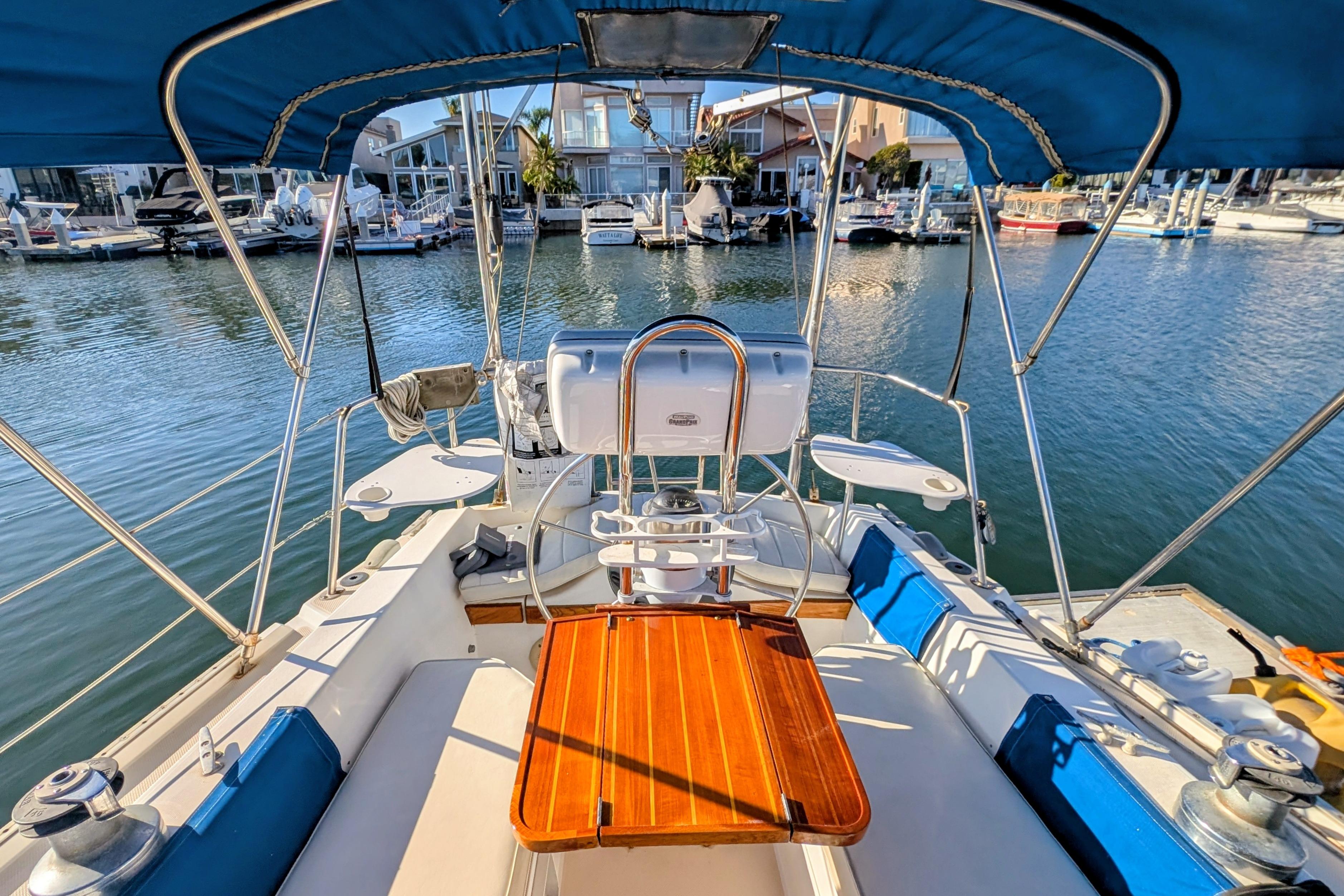 Cockpit view of a 1989 Catalina 34 sailboat docked in a marina.