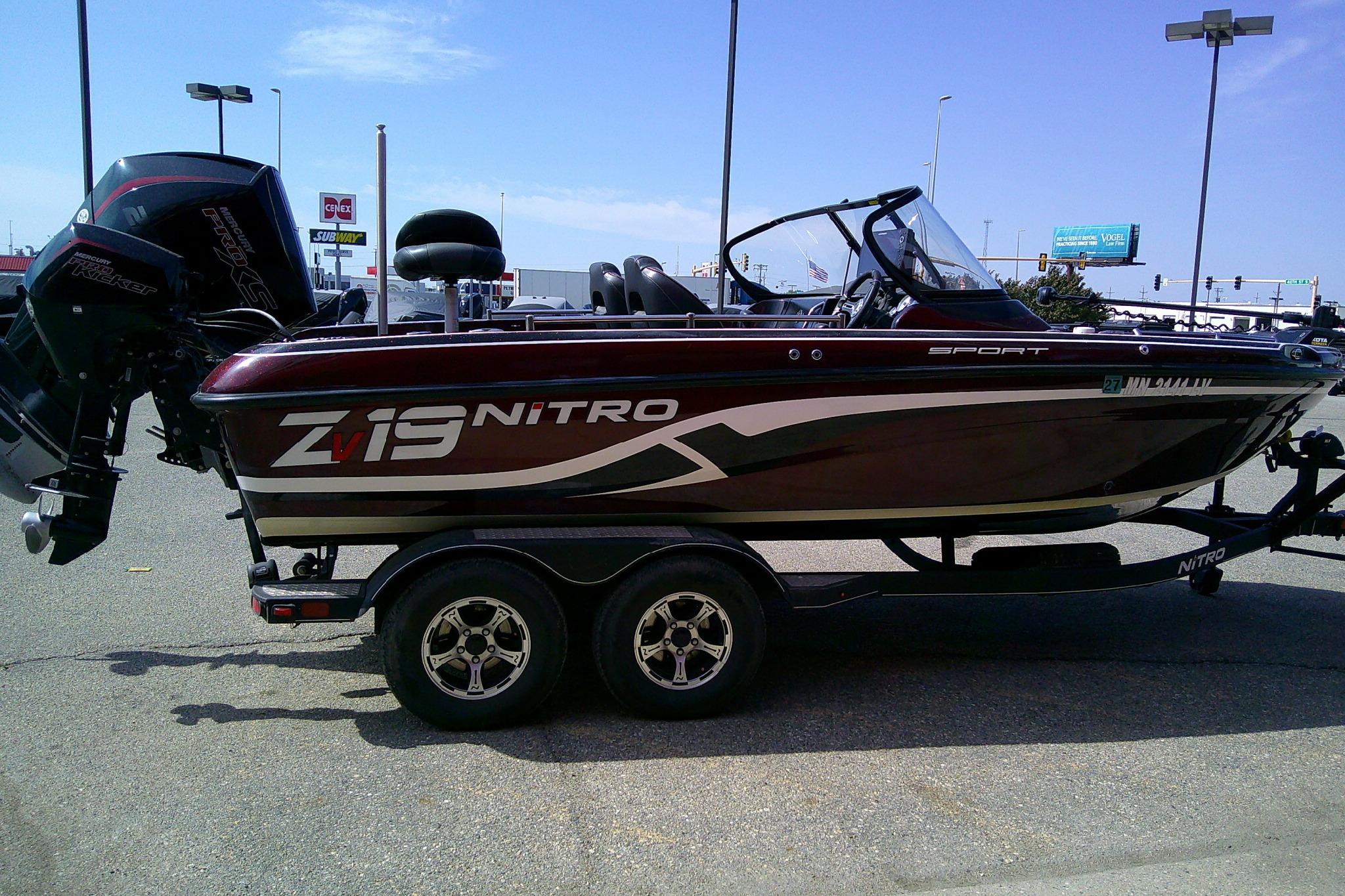 2019 Nitro ZV19 Sport boat on trailer in parking lot, side view.