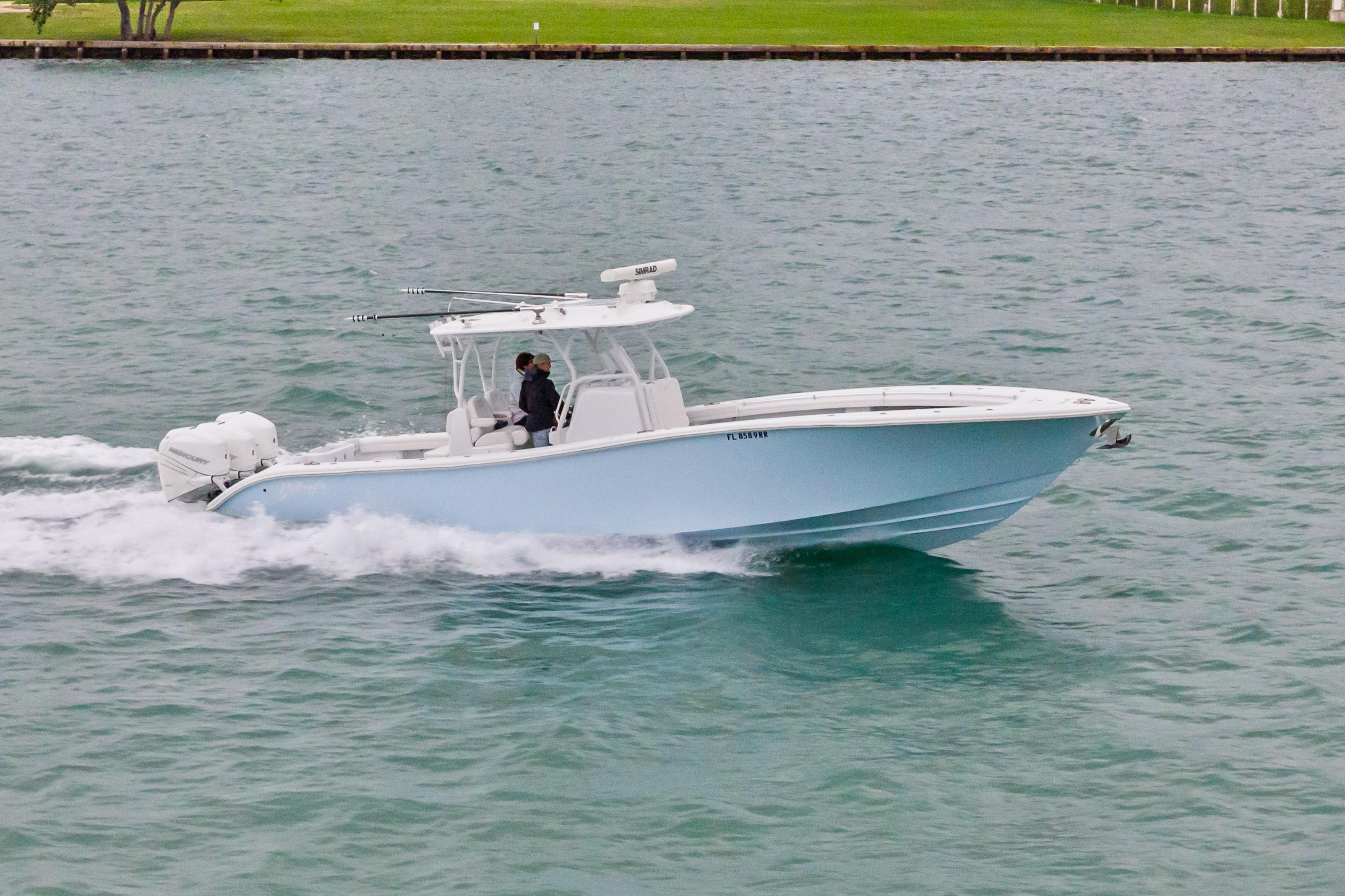 2021 Yellowfin 36 Offshore boat cruising on water, side view.