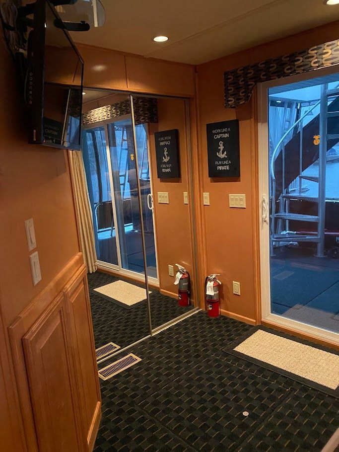 Interior of a 2006 Summersun Houseboats 16x68 with mirrors and fire extinguishers.