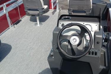 2026 Sun Tracker Bass Buggy 18 DLX boat interior with steering wheel and seating.