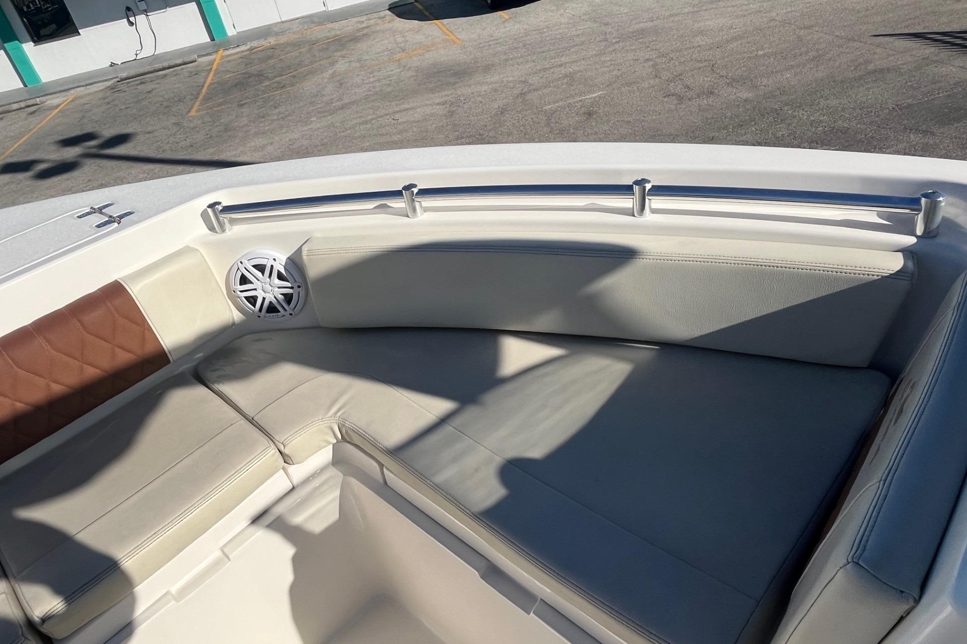 2023 Cobia 220 Dual Console boat interior with cushioned seating and speaker.