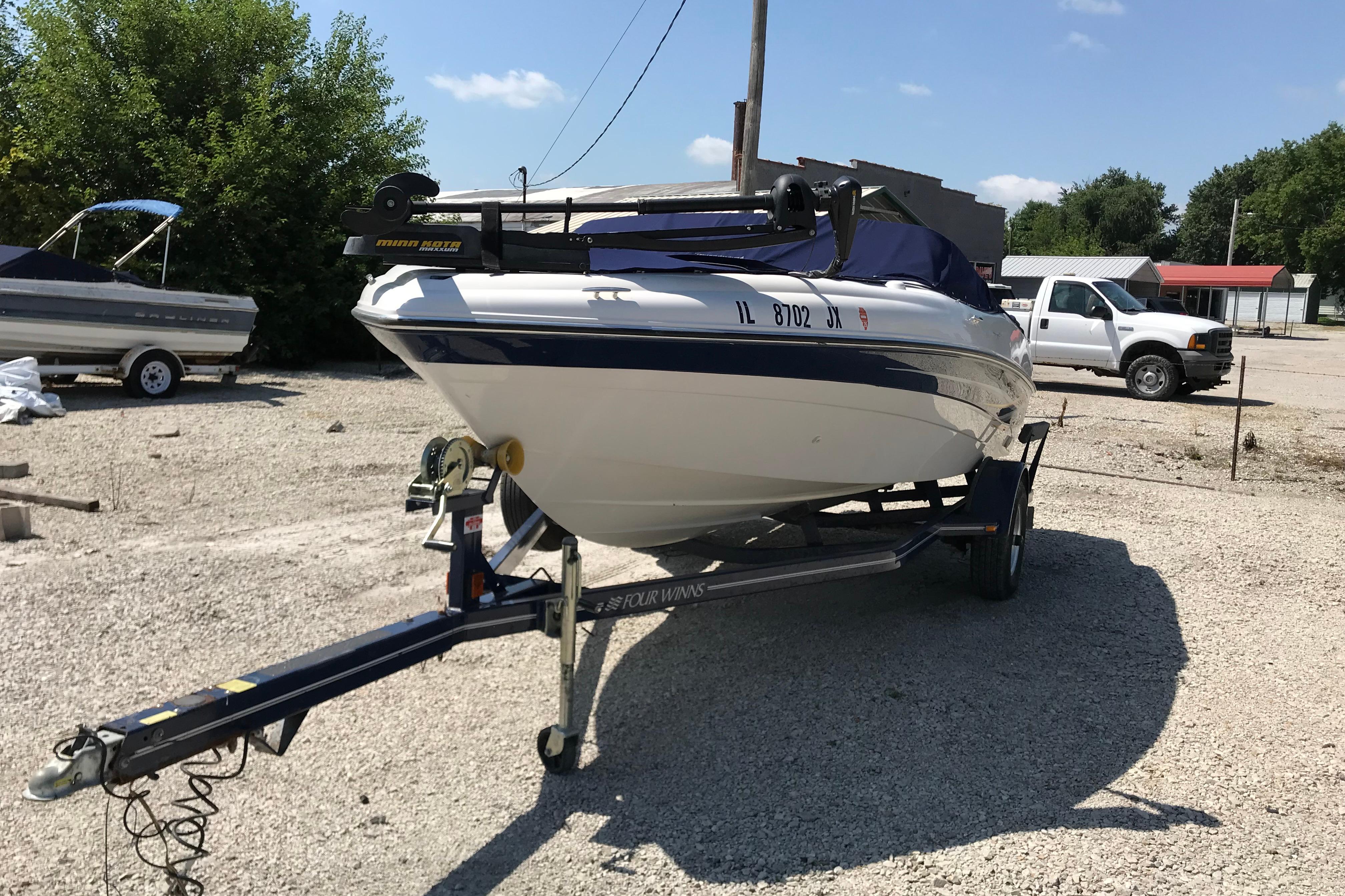 2005 Four Winns 180 Horizon FS boat on trailer in outdoor setting.
