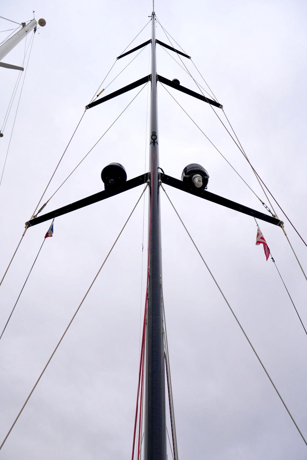 Mast of a 2018 Hanse 675 sailboat against a gray sky.