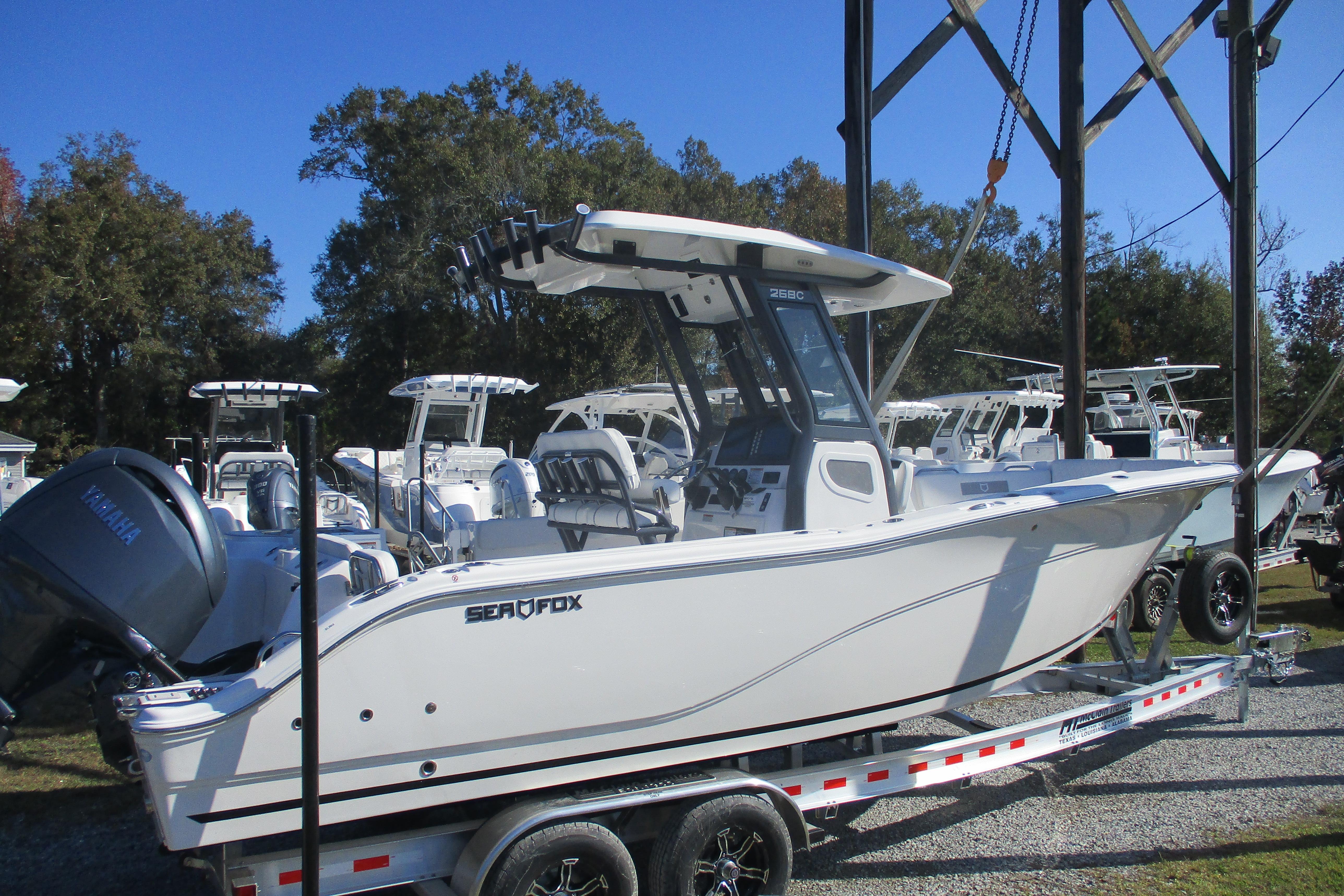 2026 Sea Fox 268 Commander boat on trailer, displayed outdoors under clear blue sky.