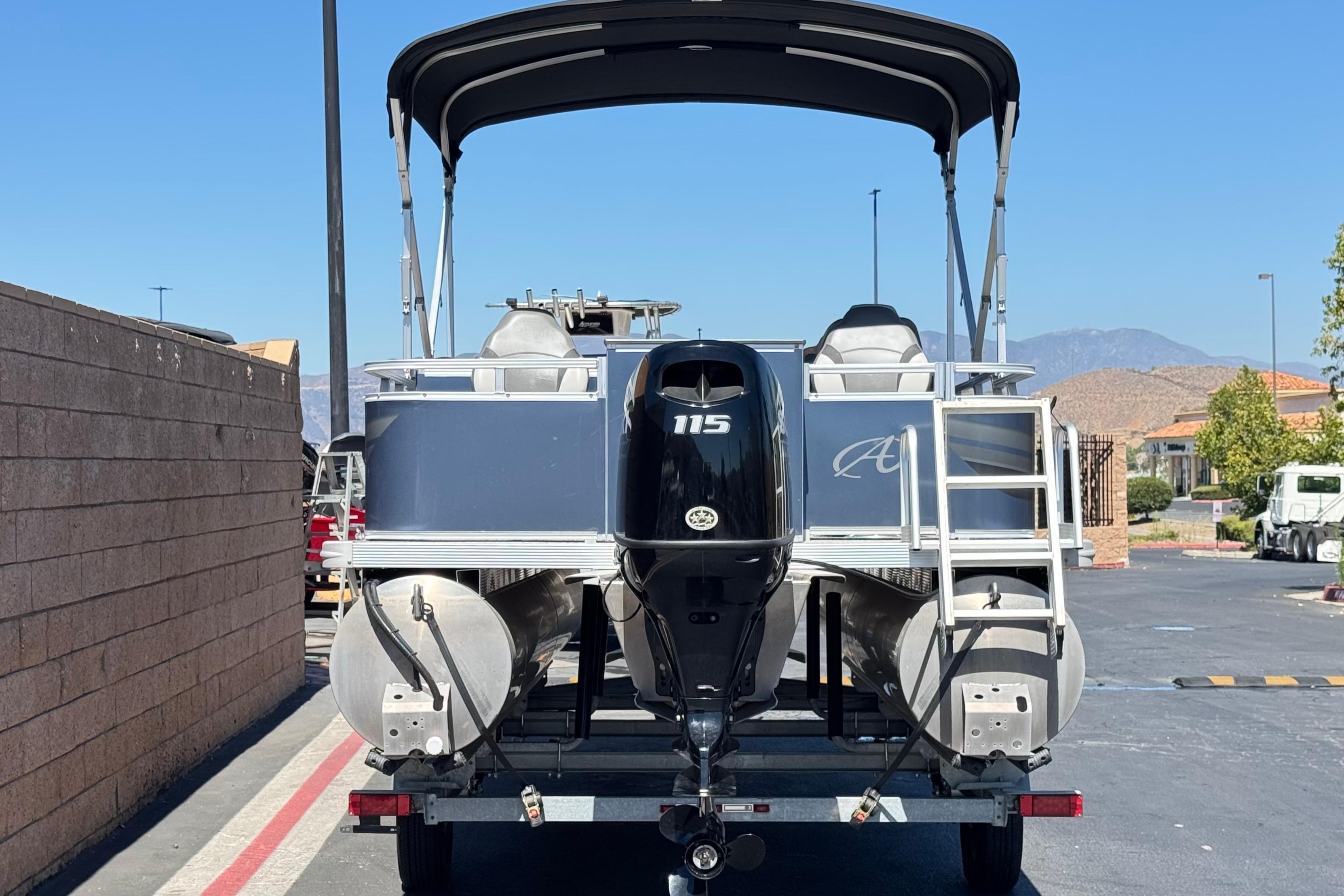 2023 Avalon Venture Fish N Cruise 20' pontoon boat with 115 HP motor, parked outdoors.