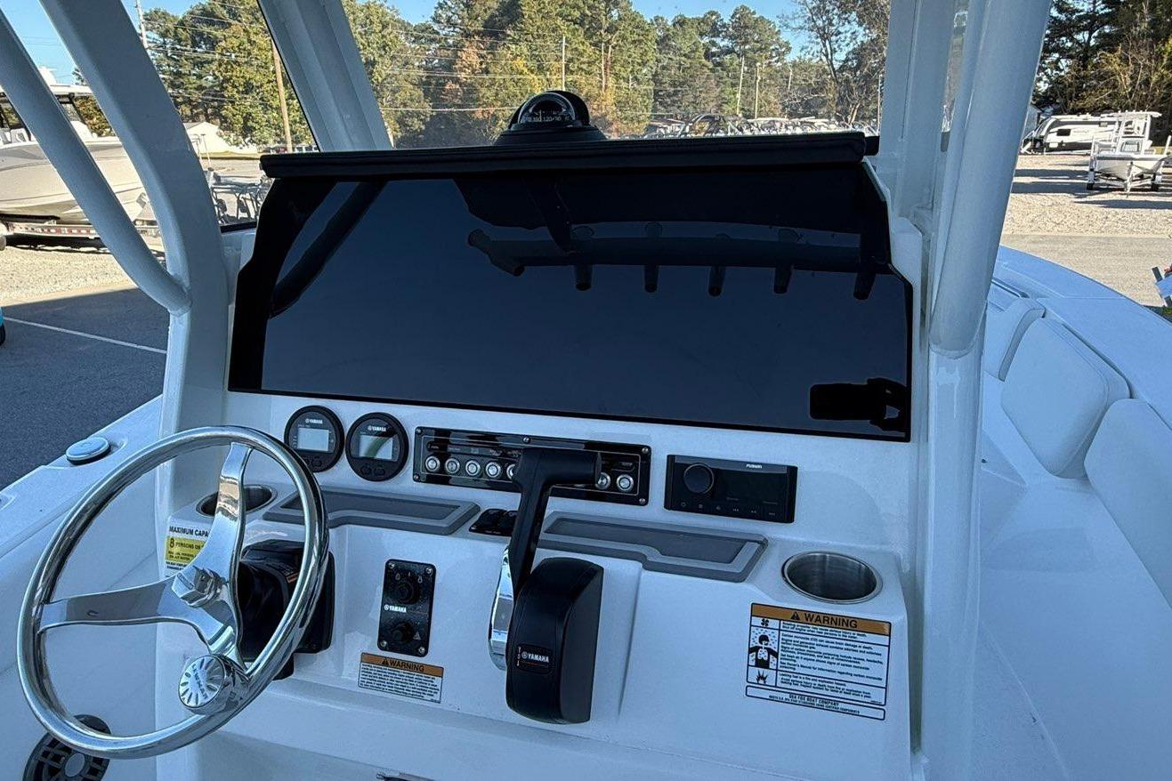 2026 Sea Fox 228 Commander boat dashboard with steering wheel and controls.