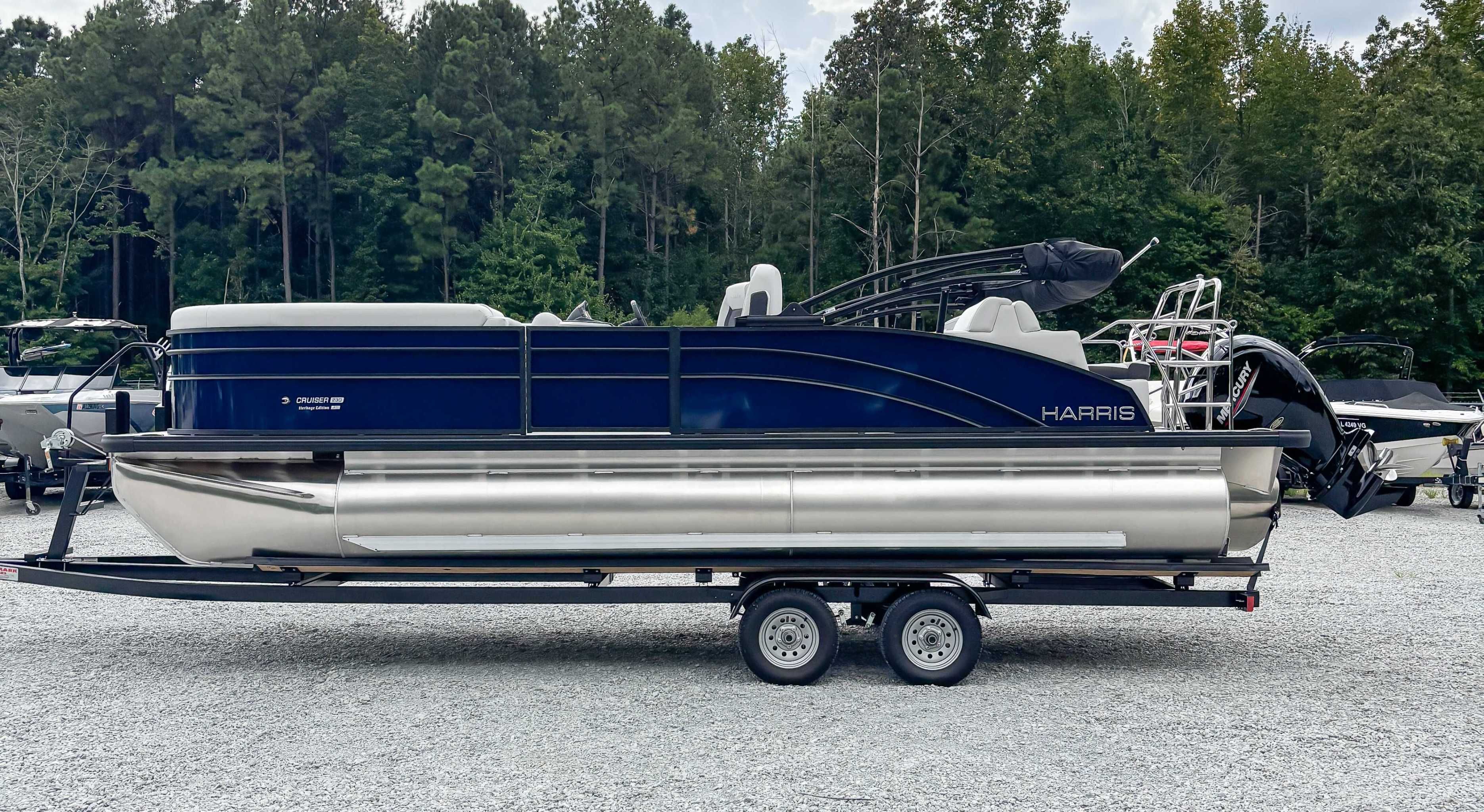 2026 Harris Cruiser 230 SLDH pontoon boat on trailer outdoors.