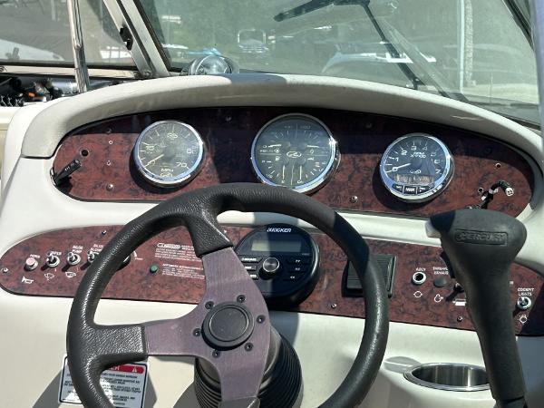 Dashboard of 2005 Sea Ray 240 SD boat with steering wheel and gauges.