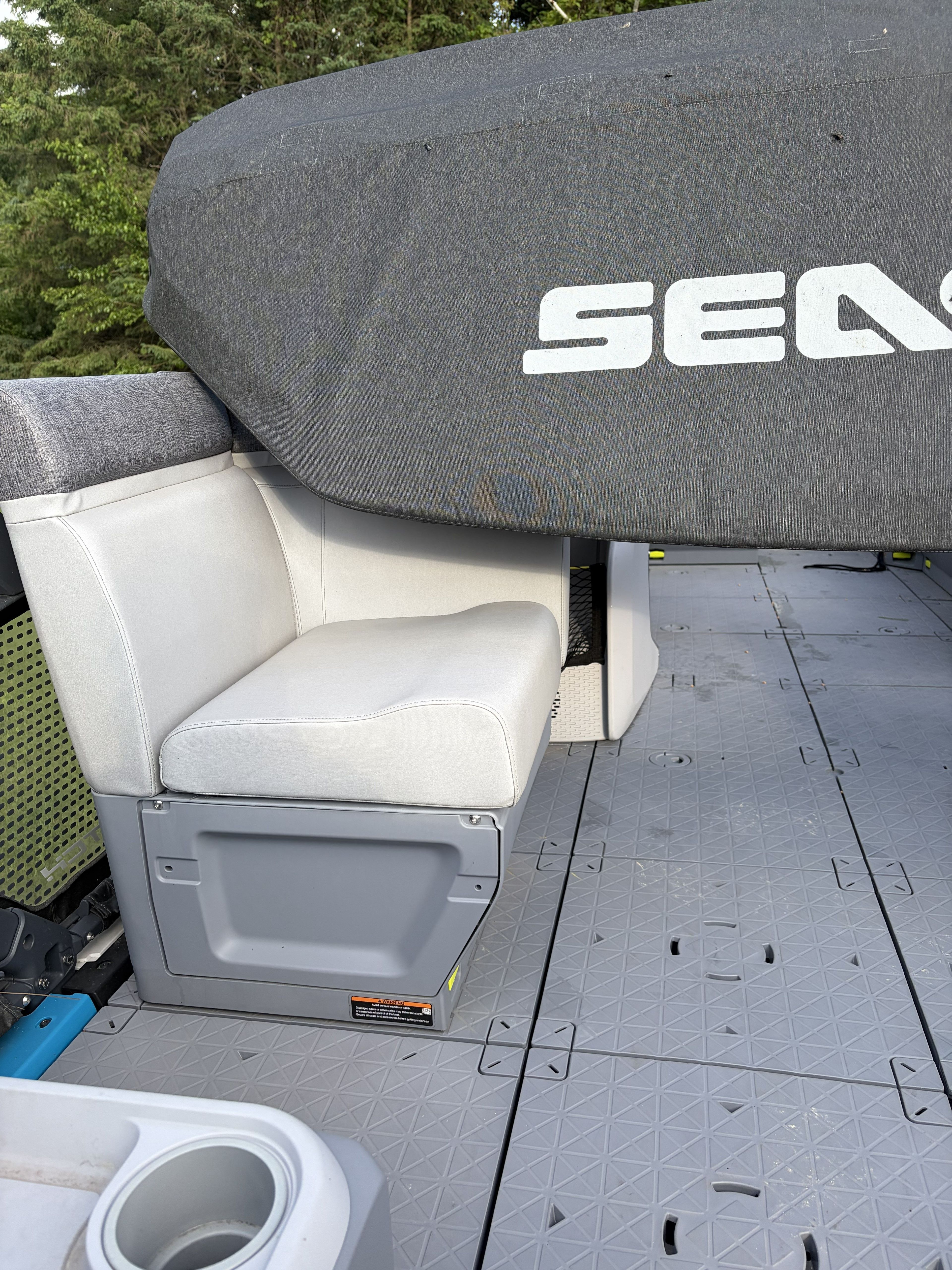 Interior of a Sea Doo Switch with gray upholstery and cover.