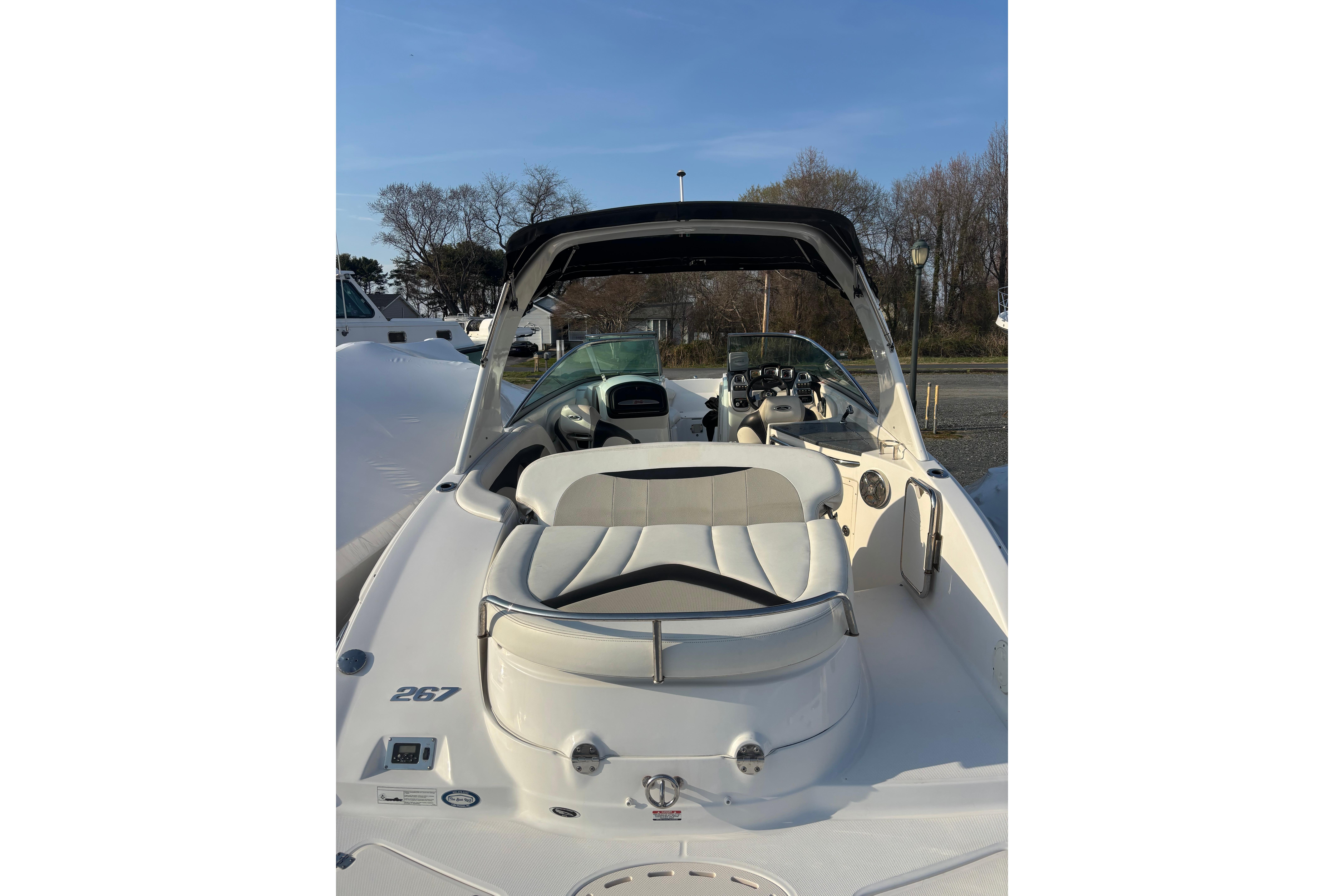 2012 Chaparral 267 SSX boat with white seating and sleek design.