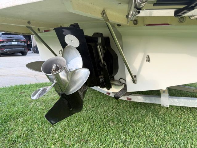 Bayliner 184 SF 2012 boat hull and propeller on grass.