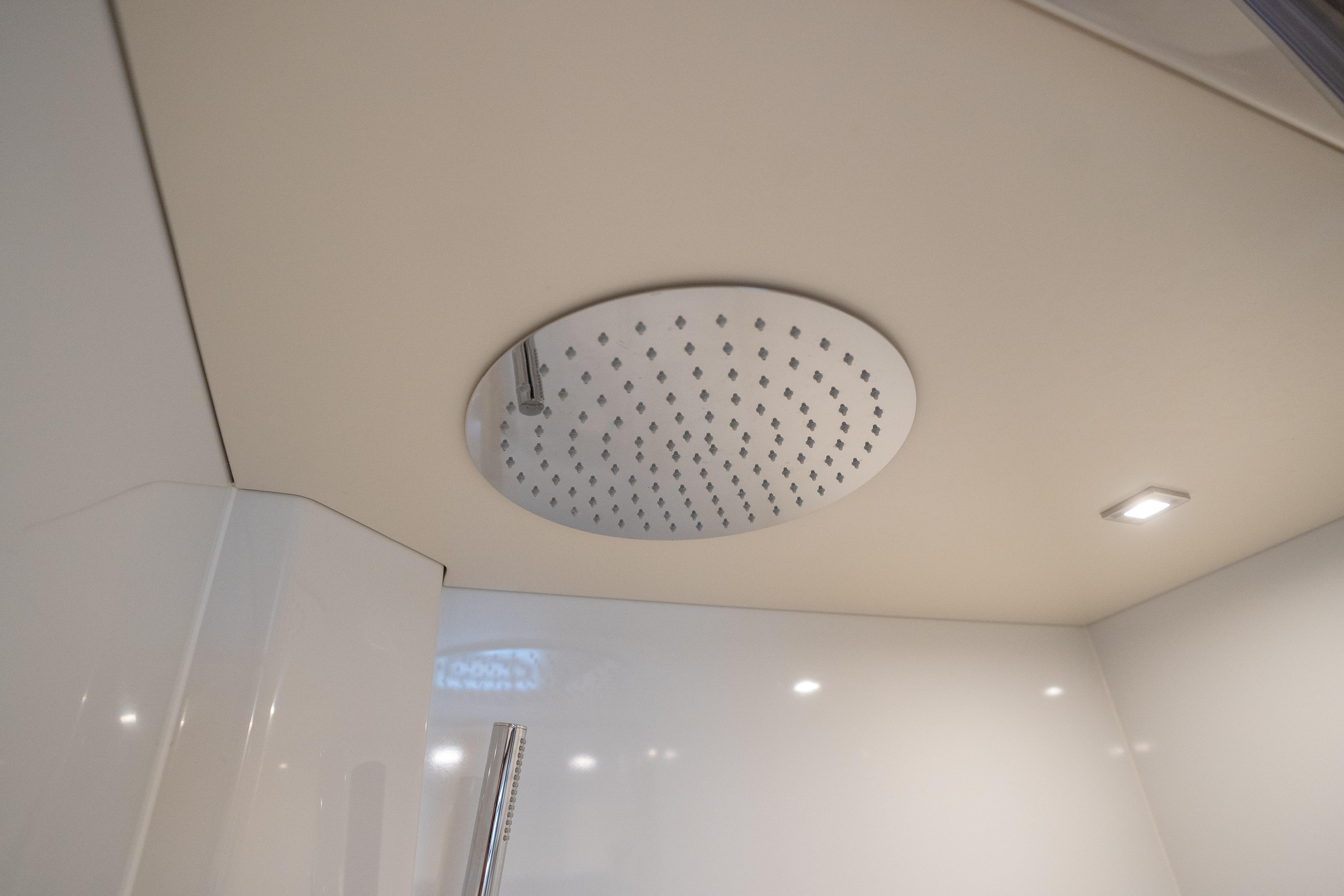 Ceiling-mounted showerhead in 2025 Sirena 58 yacht bathroom.
