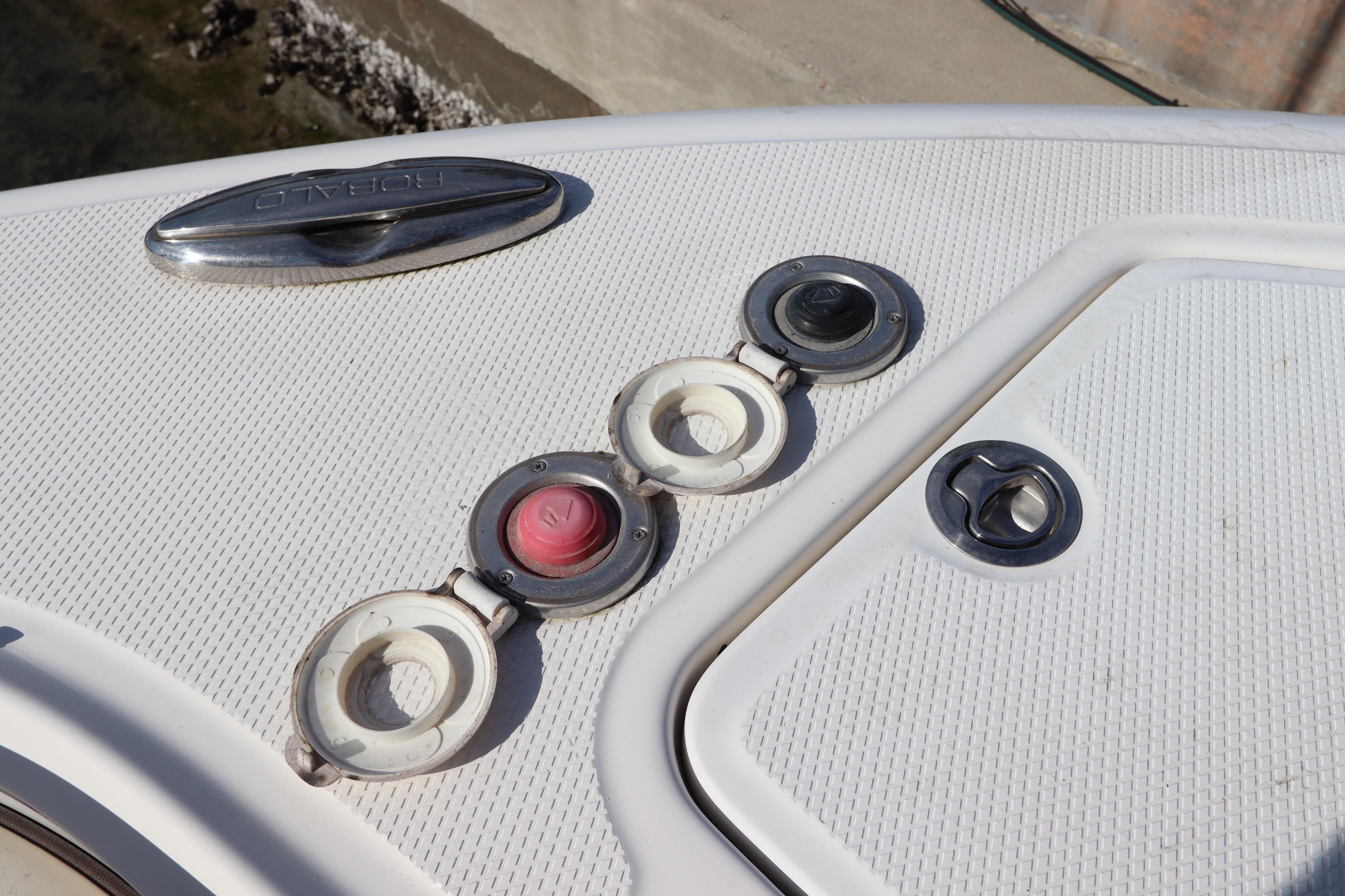 2019 Robalo R242 Center Console boat deck with fittings and hatches.