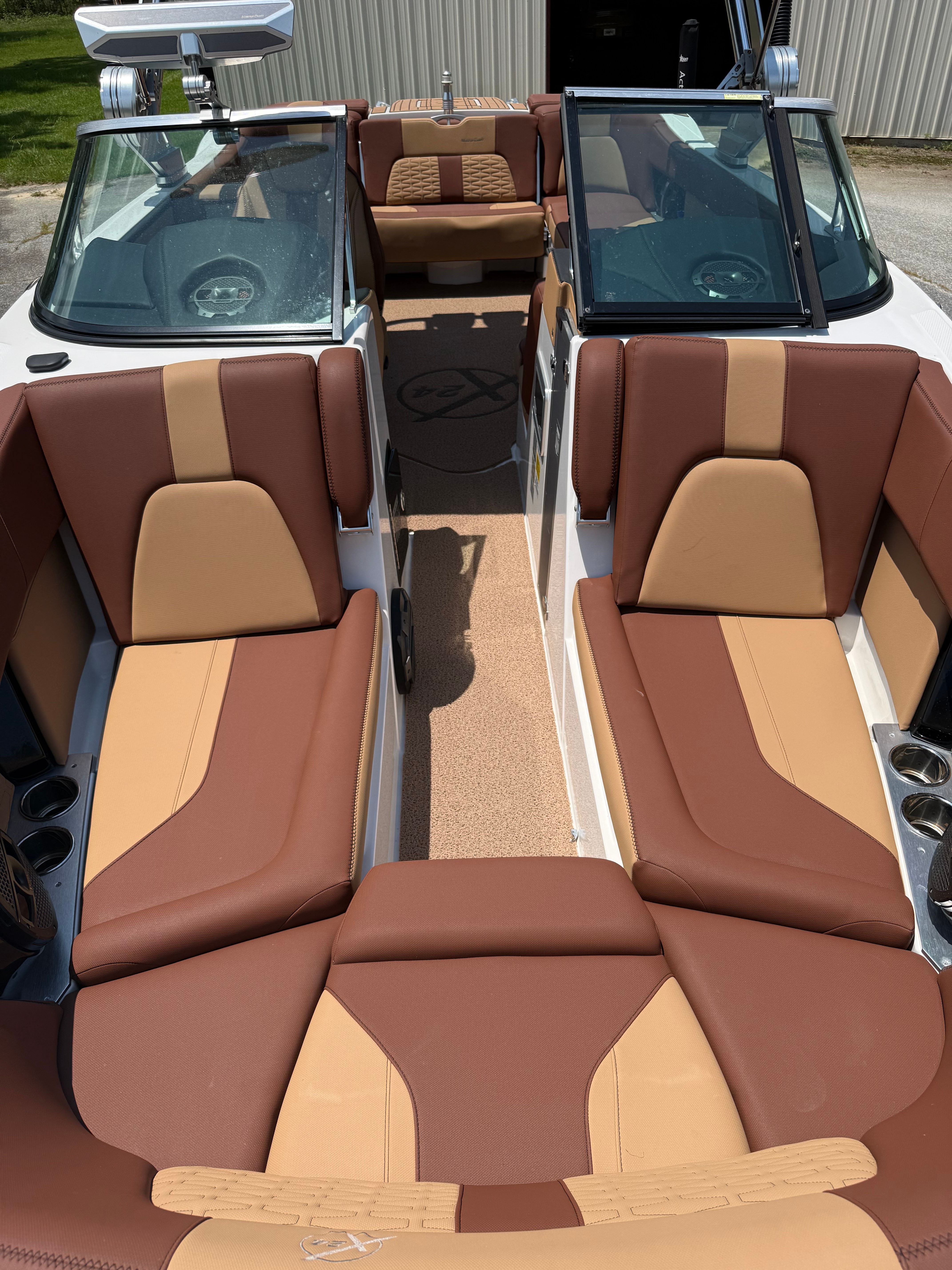 Interior view of a MasterCraft X24 boat with brown and beige seating.