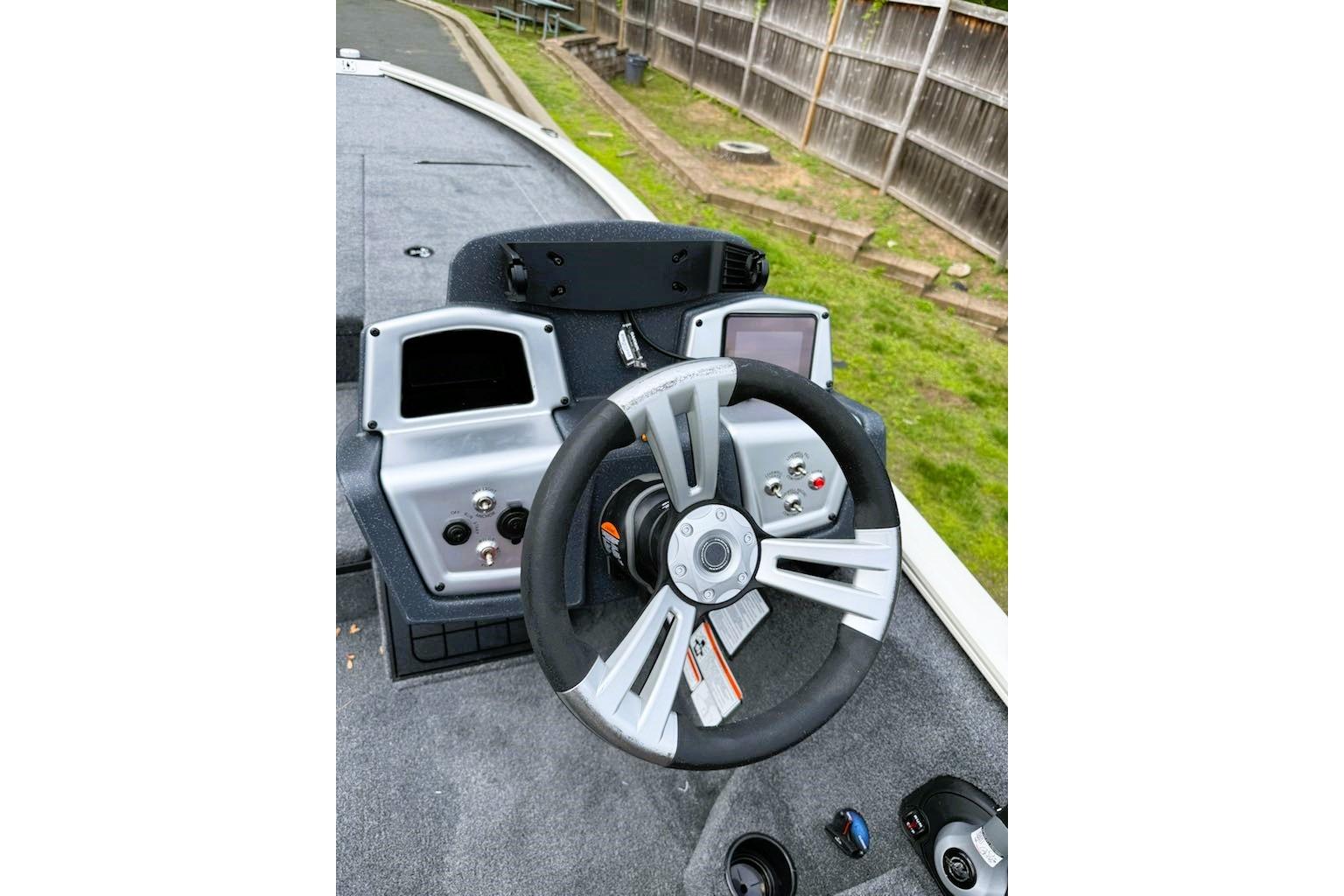Steering console of 2025 Tracker Savage 215 boat with modern controls and dashboard.