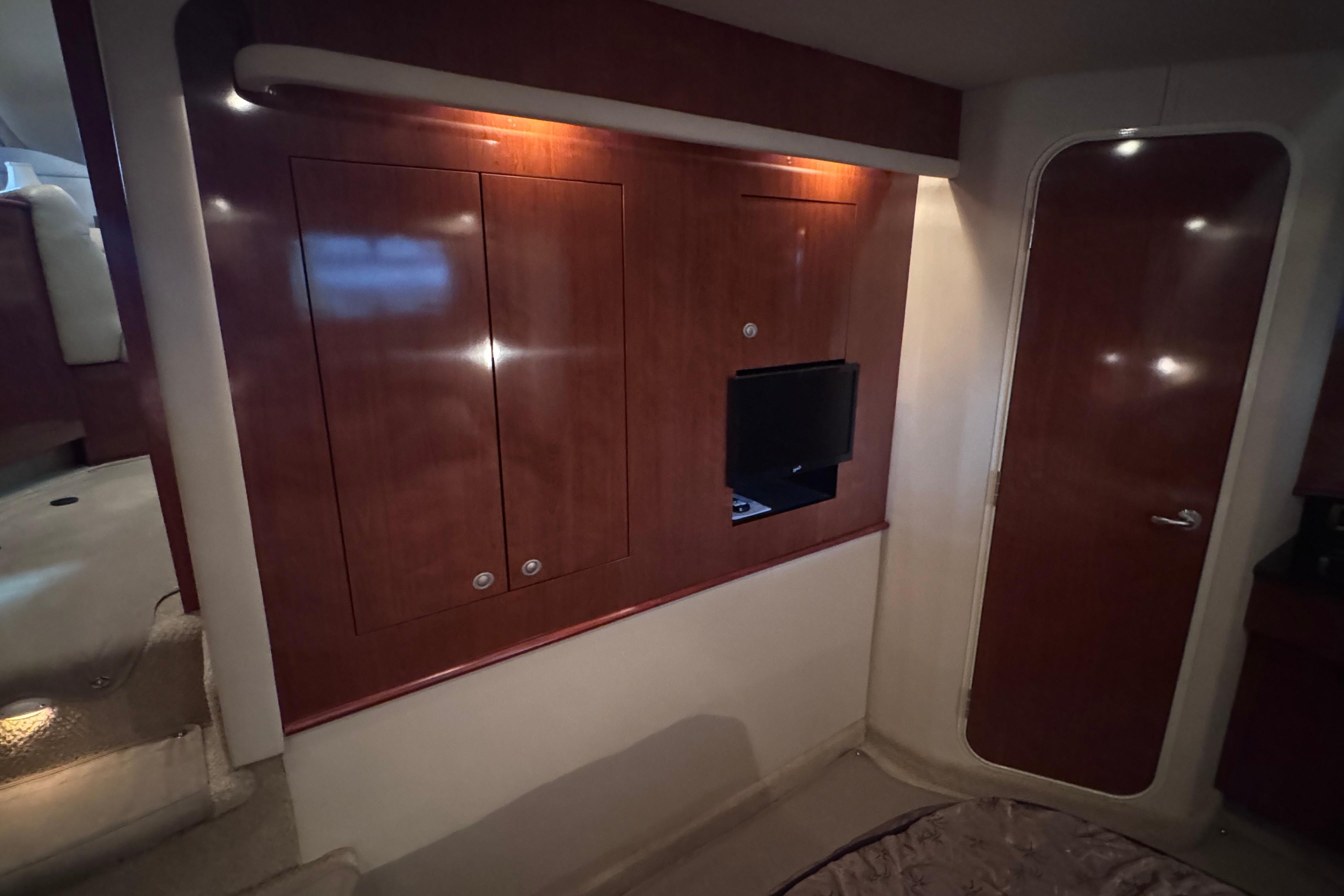 Interior of 2004 Sea Ray 390 Motor Yacht with wood paneling and built-in TV.