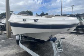 2021 Hurricane SunDeck Sport 192 RL OB boat on trailer, parked outdoors.